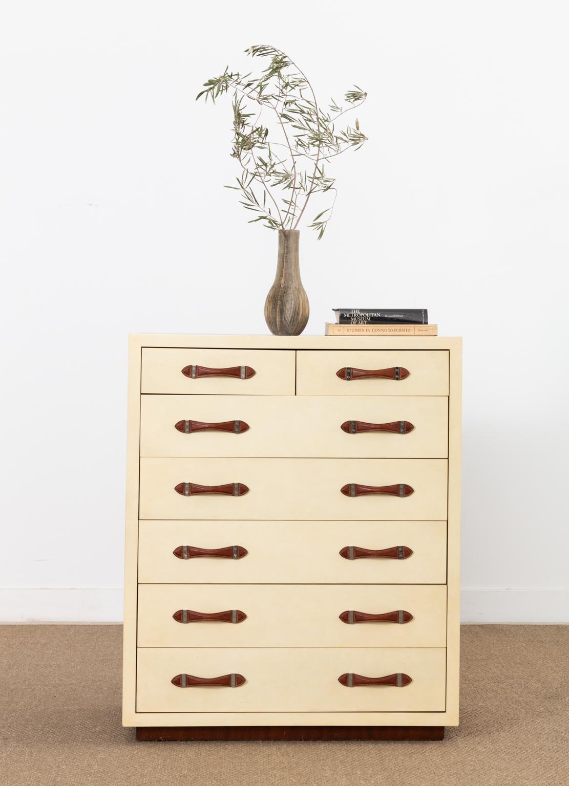 Gorgeous mahogany dresser or chest of drawers by Ralph Lauren from the modern Hollywood collection. The dresser features a mahogany veneered case with a cream parchment clad front. There are five large storage drawers and two smaller drawers each