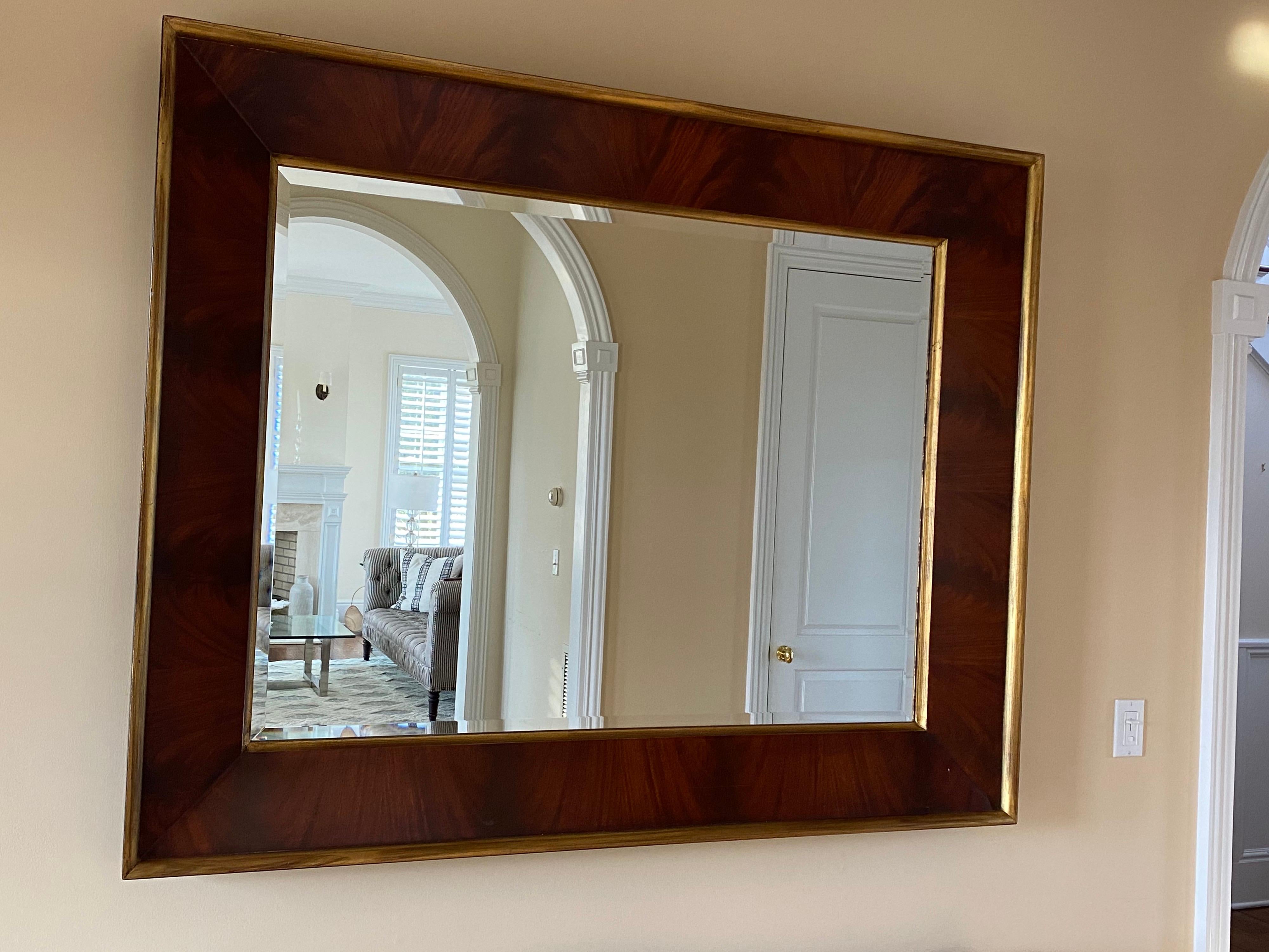 City modern oversize beveled wall mirror by Ralph Lauren. This mirror elegantly finished in a flame style mahogany wood with a double gold border. This is fit for any style home, modern, traditional or midcentury. This mirror sells for $5500 brand
