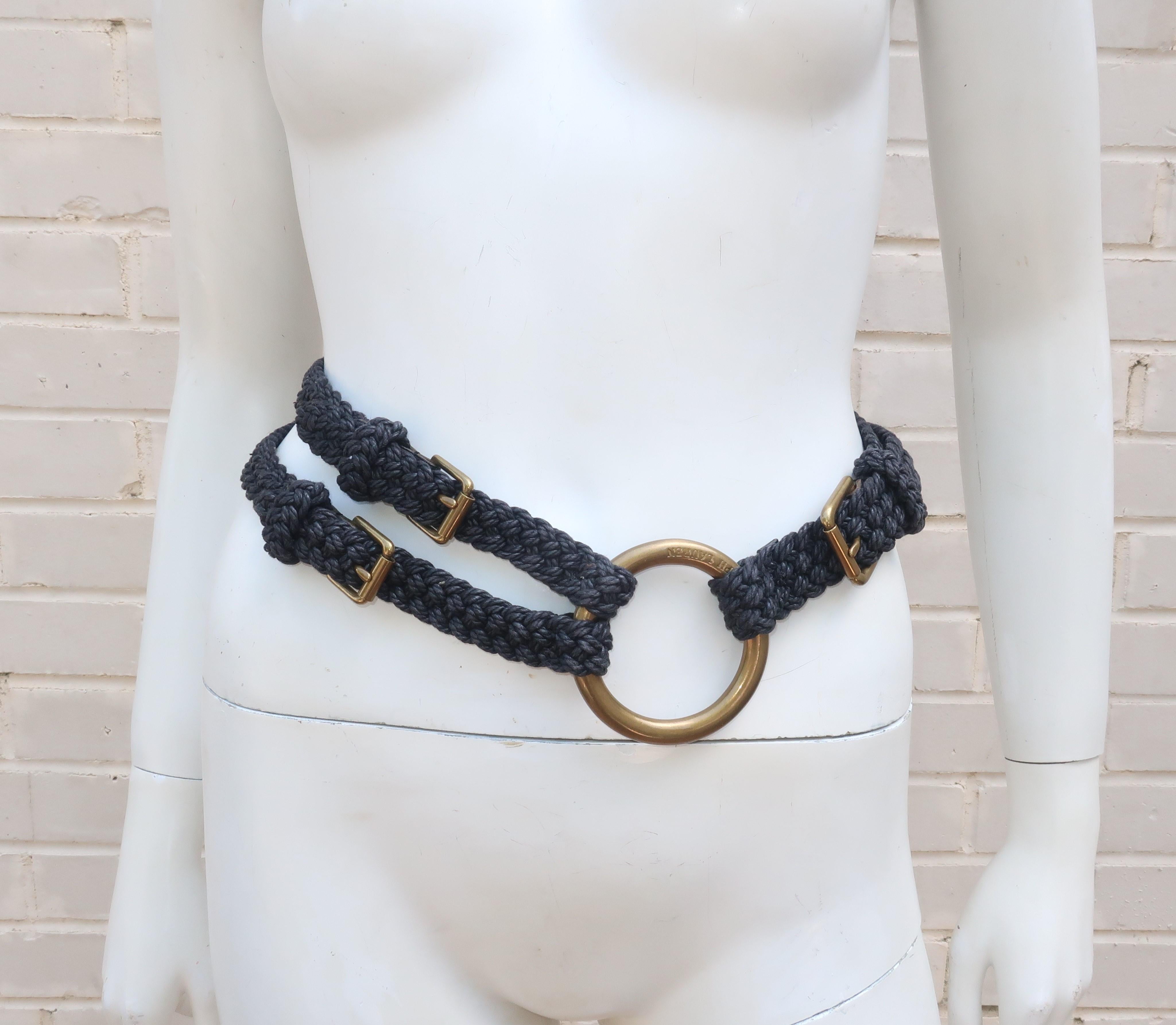 A contemporary Ralph Lauren midnight blue rope belt with a nautical inspiration and large logo embossed brass rings.  The belt features three adjustable leather and brass buckles allowing for wear in a variety of positions including a low slung