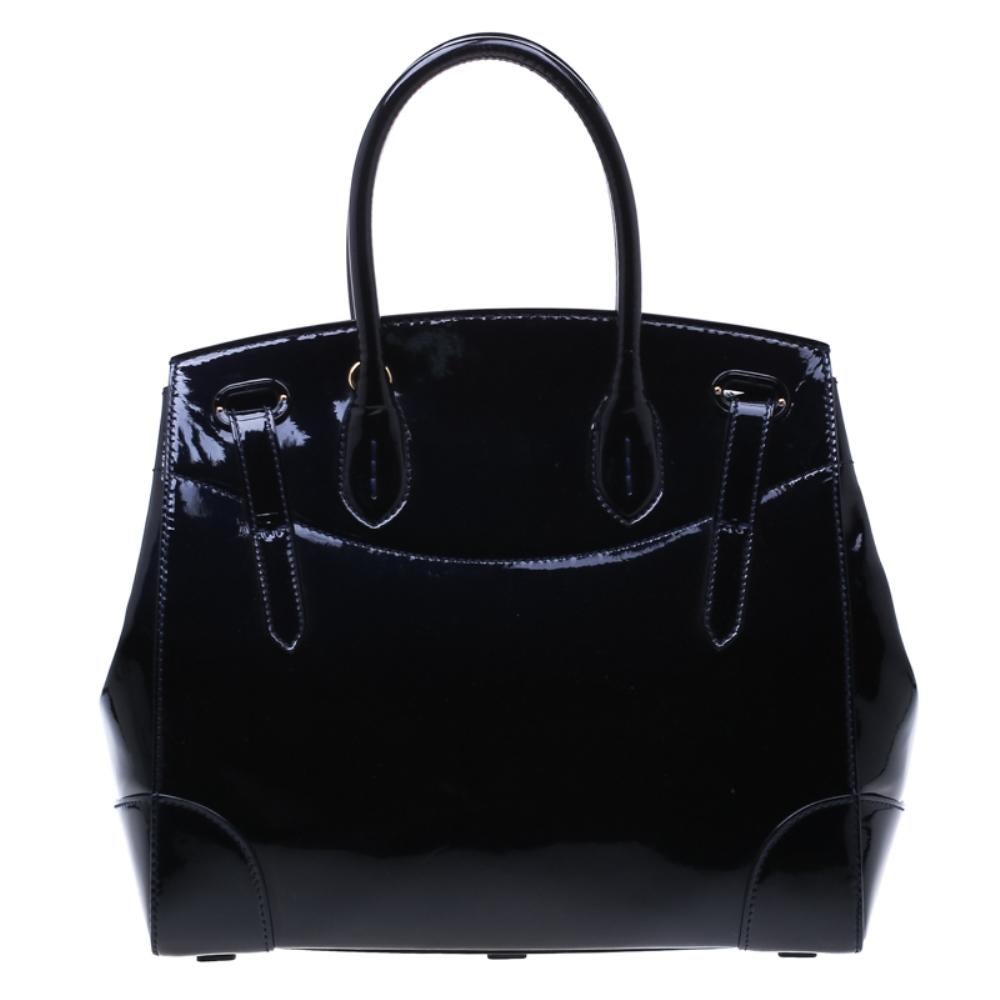 This Ralph Lauren Ricky bag is gorgeous. Meticulously crafted from patent leather, the bag delights not only with its appeal but structure as well. It is held by two top handles, detailed with gold-tone hardware and equipped with a spacious leather