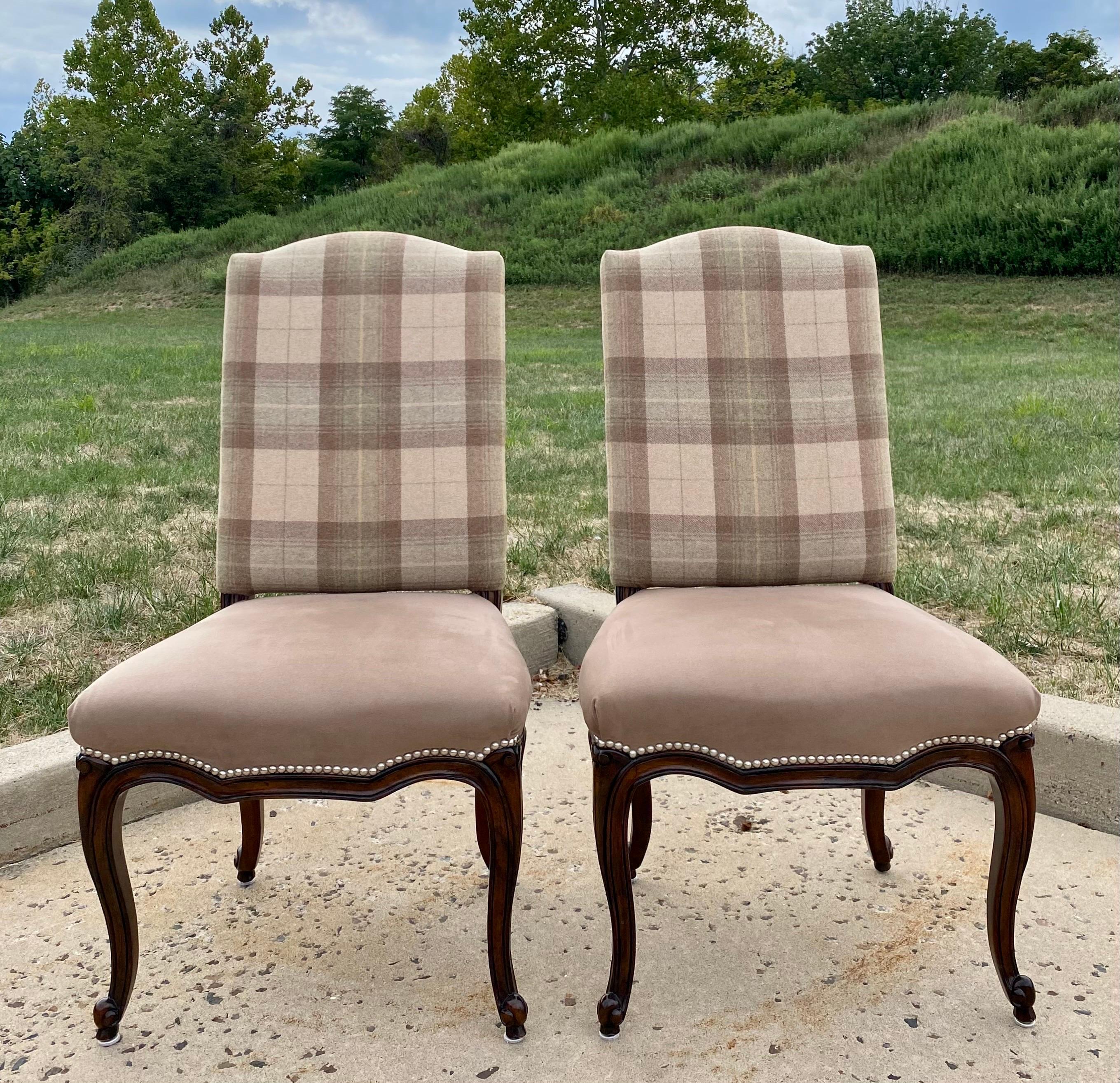 Classic Ralph Lauren Home Nobel Estate dining side chairs. Finely carved solid wood frames feature a Mahogany finish with silver nail head trim detailing and curved cabriole legs. Wool plaid upholstered backs and fronts with Ultrasuede seats. These