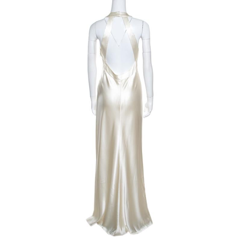 Subtle femininity and sharp tailoring define this off-white gown from Ralph Lauren. It is an elegant piece that you can flaunt on your next black-tie event. Graced with an appropriate length, this sleeveless dress is accented with a cutout back that