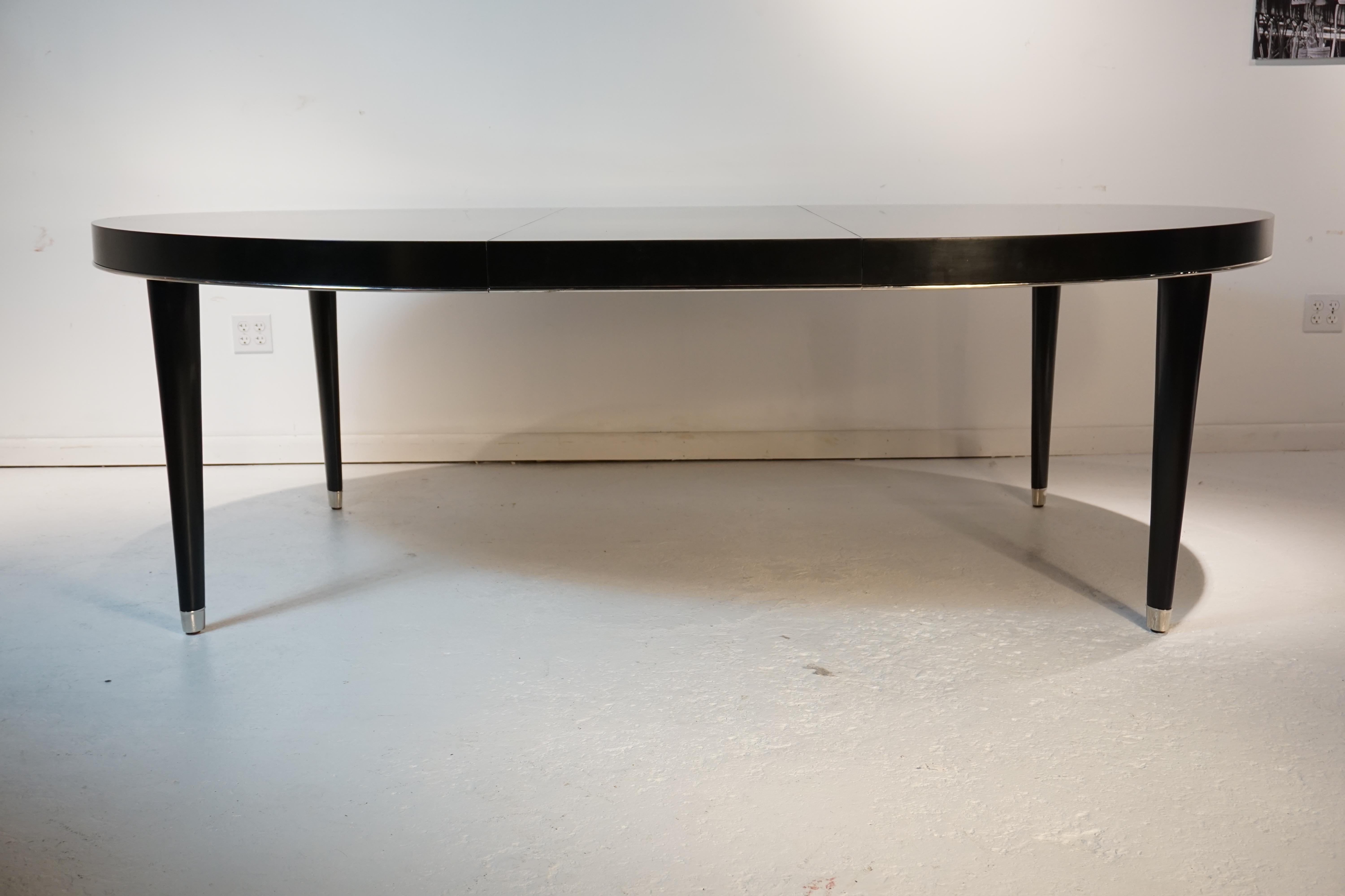 Incredible iconic ralph Lauren dining table. Beautiful black lacquer with silver trim and feet. Extension to 96 inches. Statement piece for any dining space.