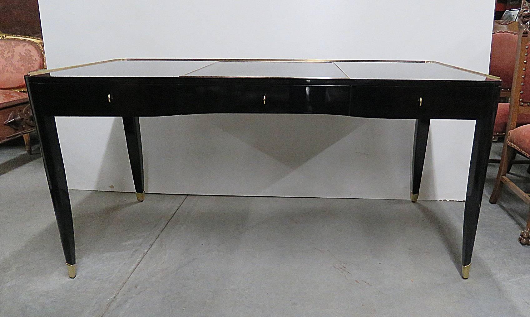 Ralph Lauren on fifth Paris desk. High gloss black lacquered desk with three drawers, brass accents and elegant tapered legs.