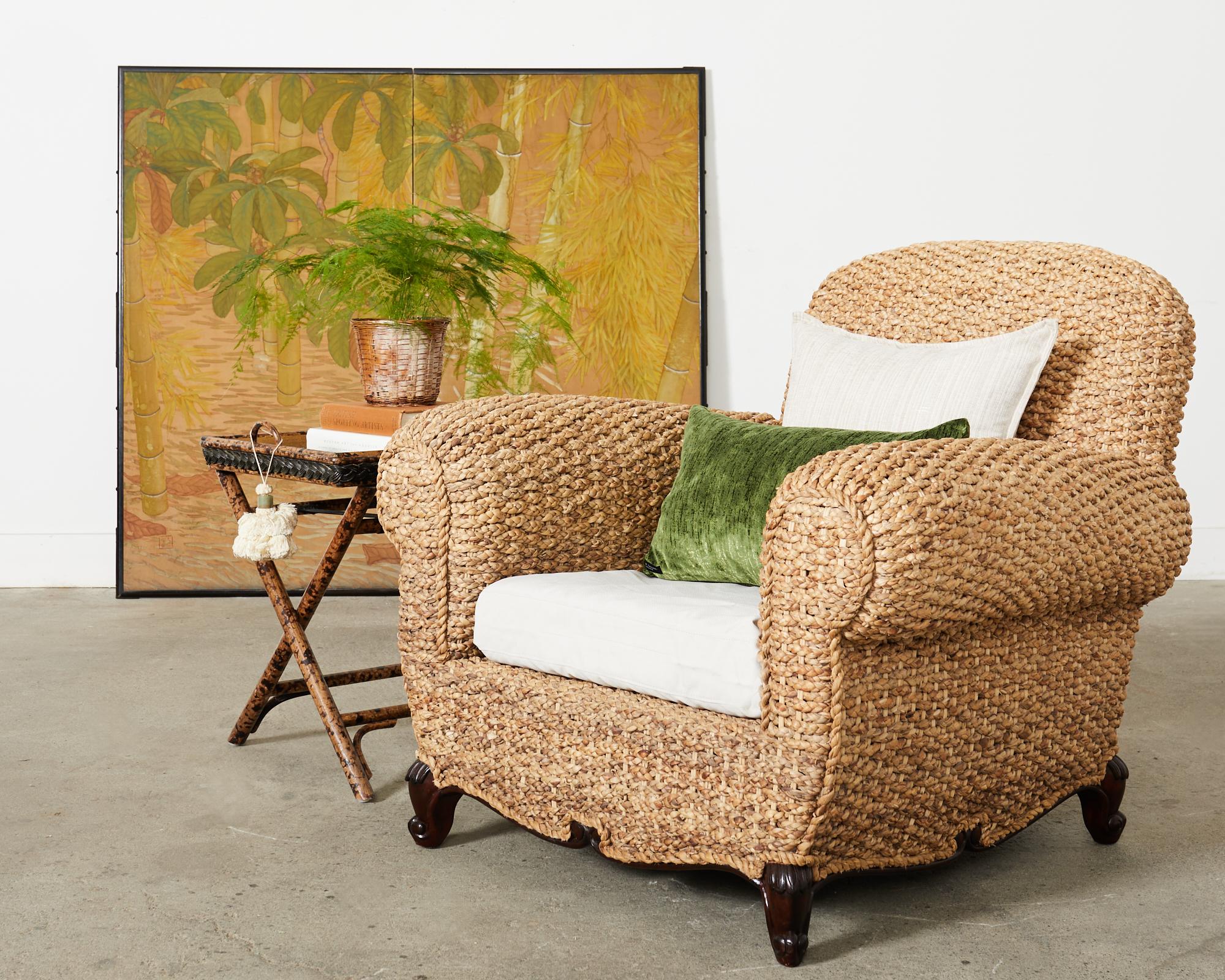 Gorgeous organic modern lounge chair or club chair made in the manner of Louis Quinz by Ralph Lauren. The Victoria Falls club chair is crafted from woven water hyacinth rope or seagrass.. The generous mahogany frame has large rolled arms and is