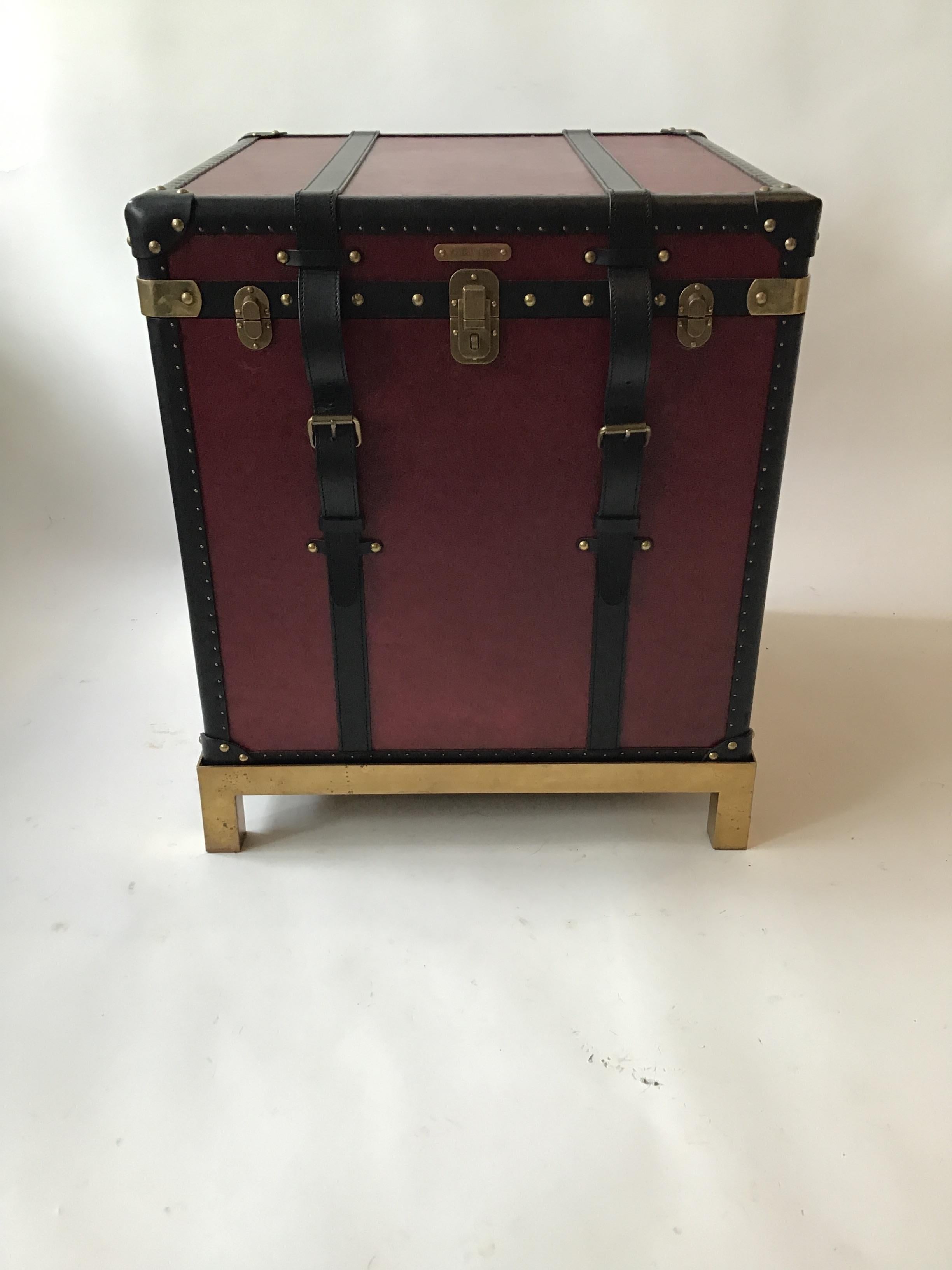 Ralph Lauren Oxford red leather trunk table on solid brass base. From a Southampton, NY estate. Leather trunk, top opens for storage.