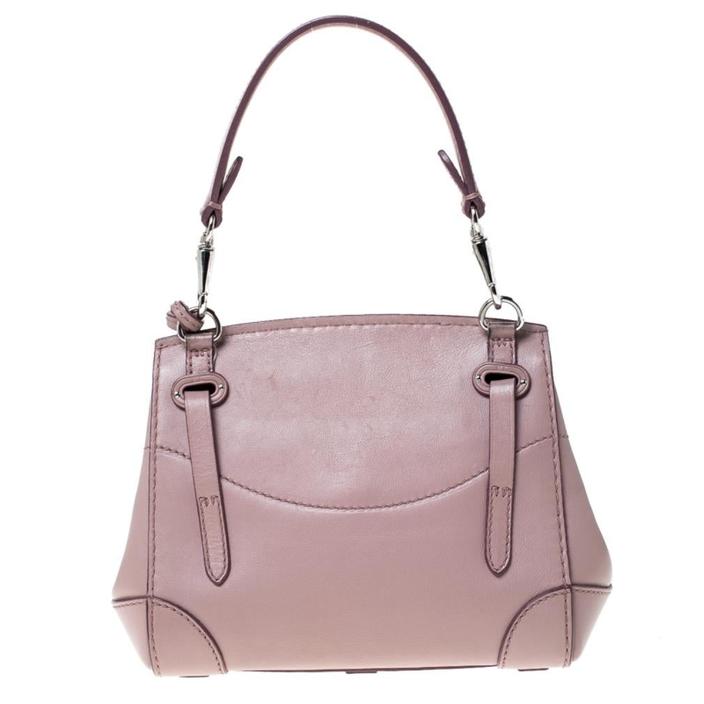 This Ralph Lauren Ricky bag is simply breathtaking. Meticulously crafted from leather, the bag delights not only with its appeal but structure as well. It is held by two top handles, detailed with silver-tone hardware and equipped with a spacious