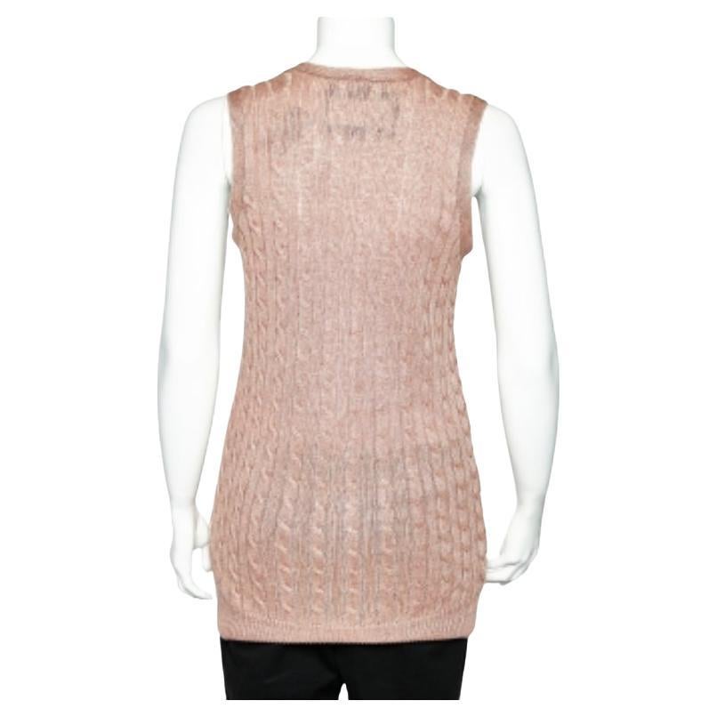 This winter season, flaunt high-end, luxurious designs that blend with your personality. This sleeveless cardigan from Ralph Lauren is a creation that adds elegance to your attire. Made with pale-pink linen cable knit, it has a button front closure