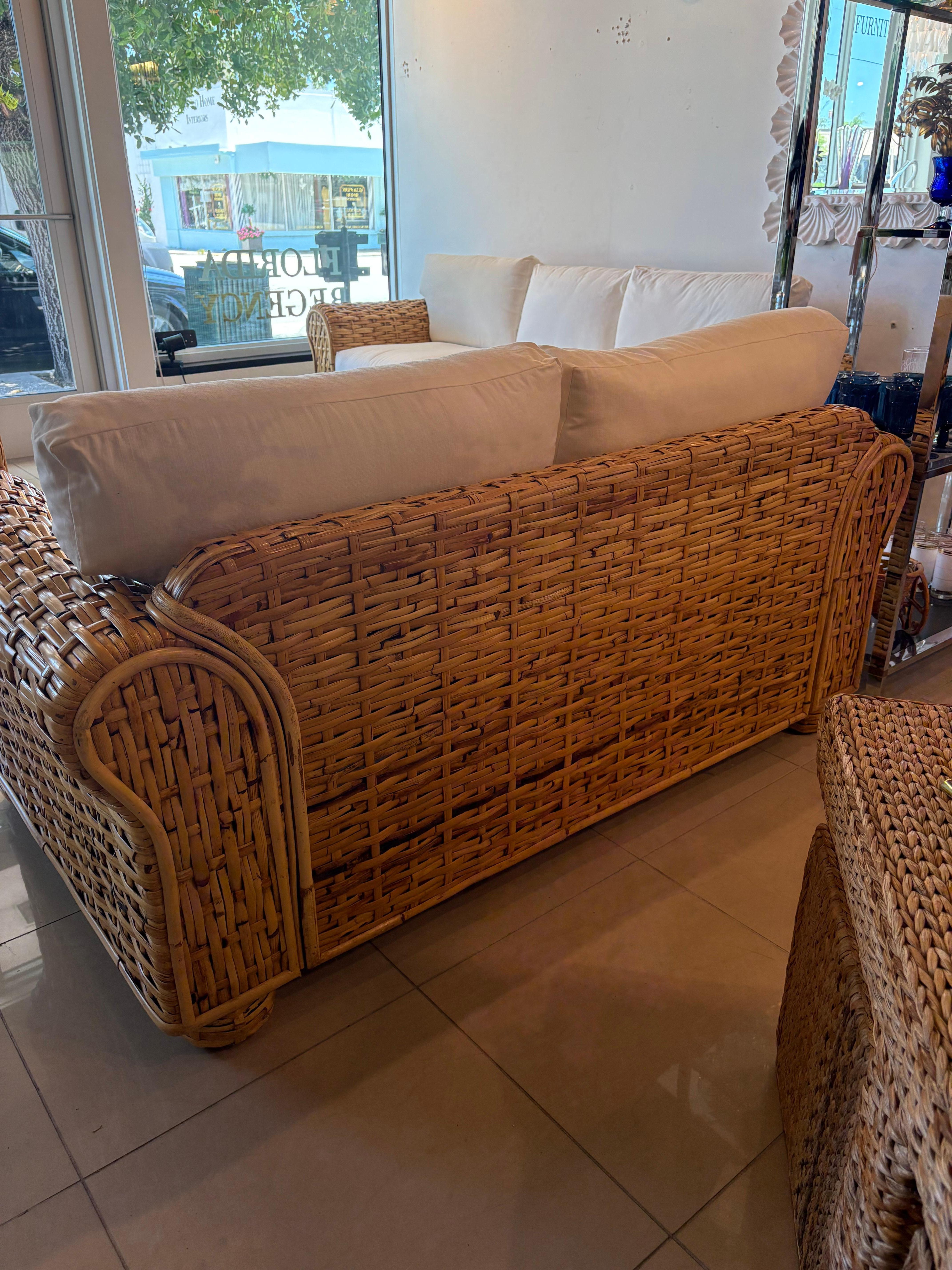 Late 20th Century Ralph Lauren Polo Home Collection woven rattan, wicker loveseat. No damage to the woven rattan. The recently upholstered white cushions are in good condition. The cushions have zippers so they can be removed. We have cleaned the