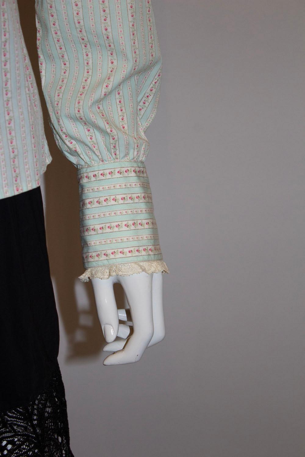 A pretty and very wearable vintage blouse by Ralph Lauren , main line.  The shirt is in a peppermint green and  pink stripe with lace collar and double button cuff.  it has a front button opening. Size 8 Measurements: Bust 37'', length 24''