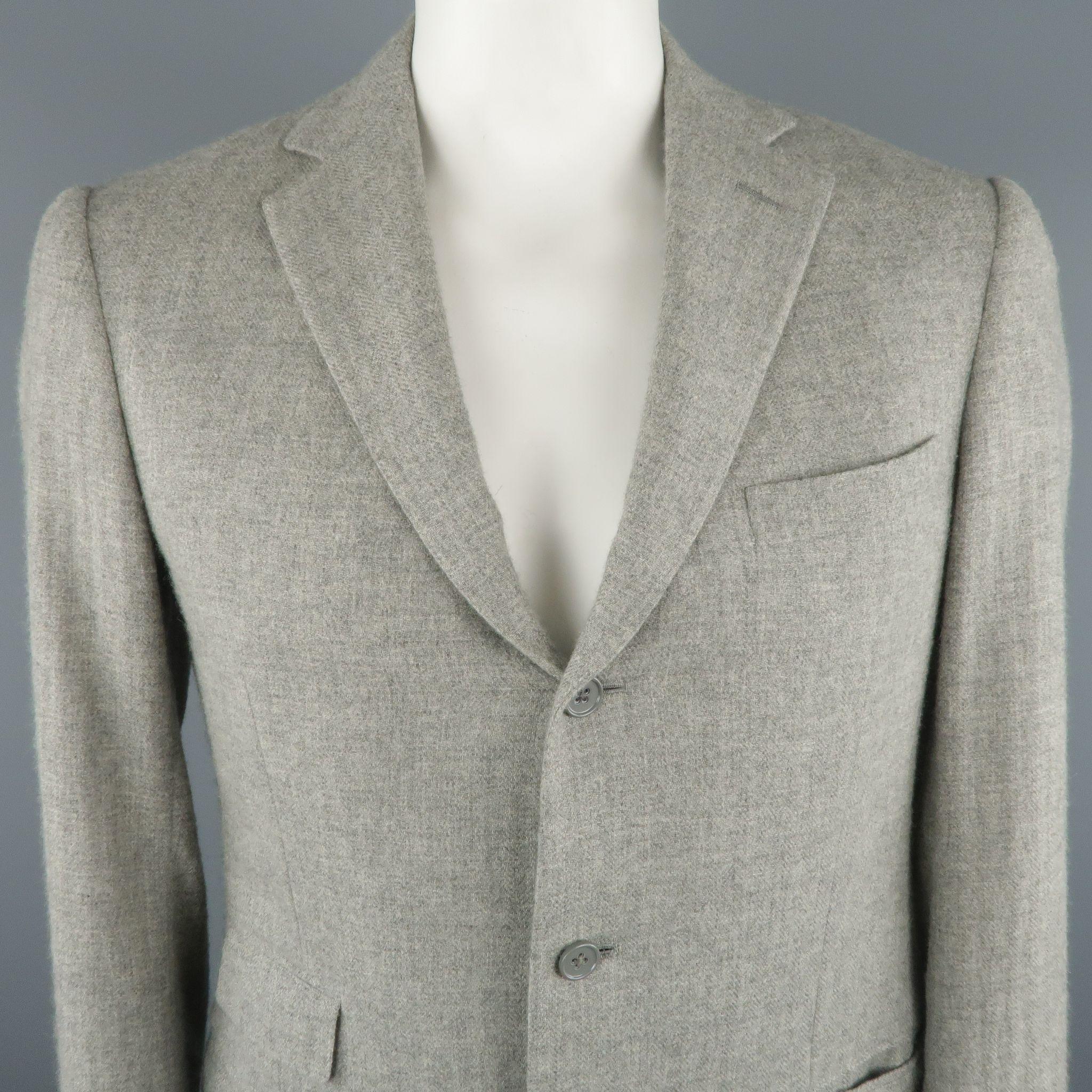 RALPH LAUREN PURPLE LABEL Long Sport Coat comes in a light grey tone in a heather cashmere material, with a notch lapel, slit and flap pockets, 3 buttons at closure, single breasted, functional buttons at cuffs and double vent at back. Made in