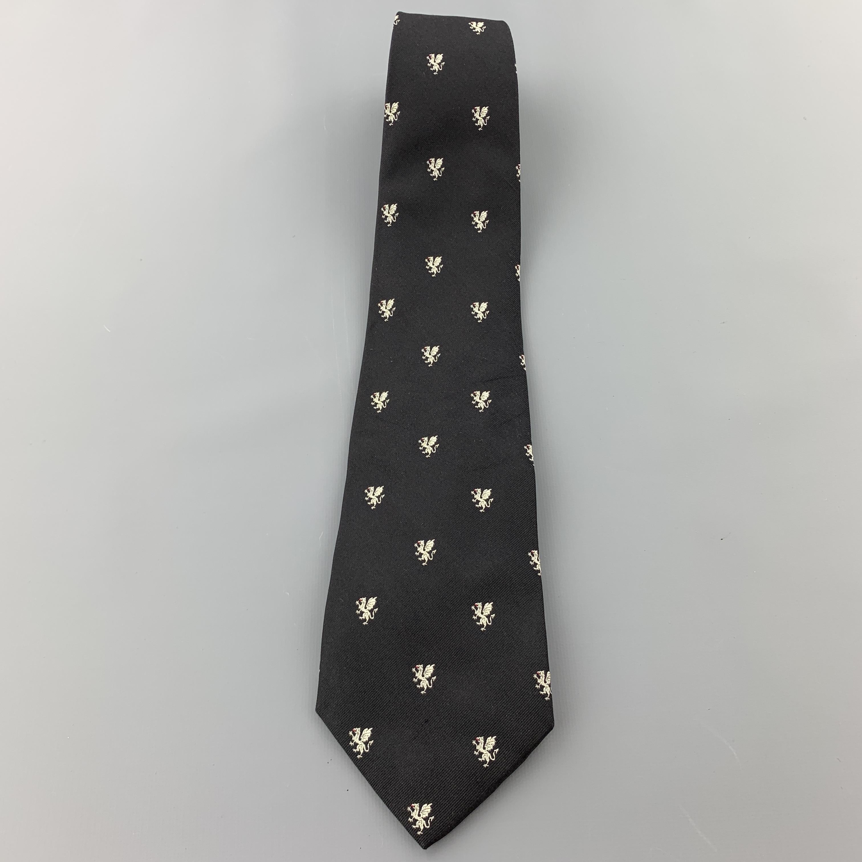 RALPH LAUREN Purple Label necktie comes in black silk twill with all over white dragon print. Hand made in Italy.

Excellent Pre-Owned Condition.

Width: 4 in.  