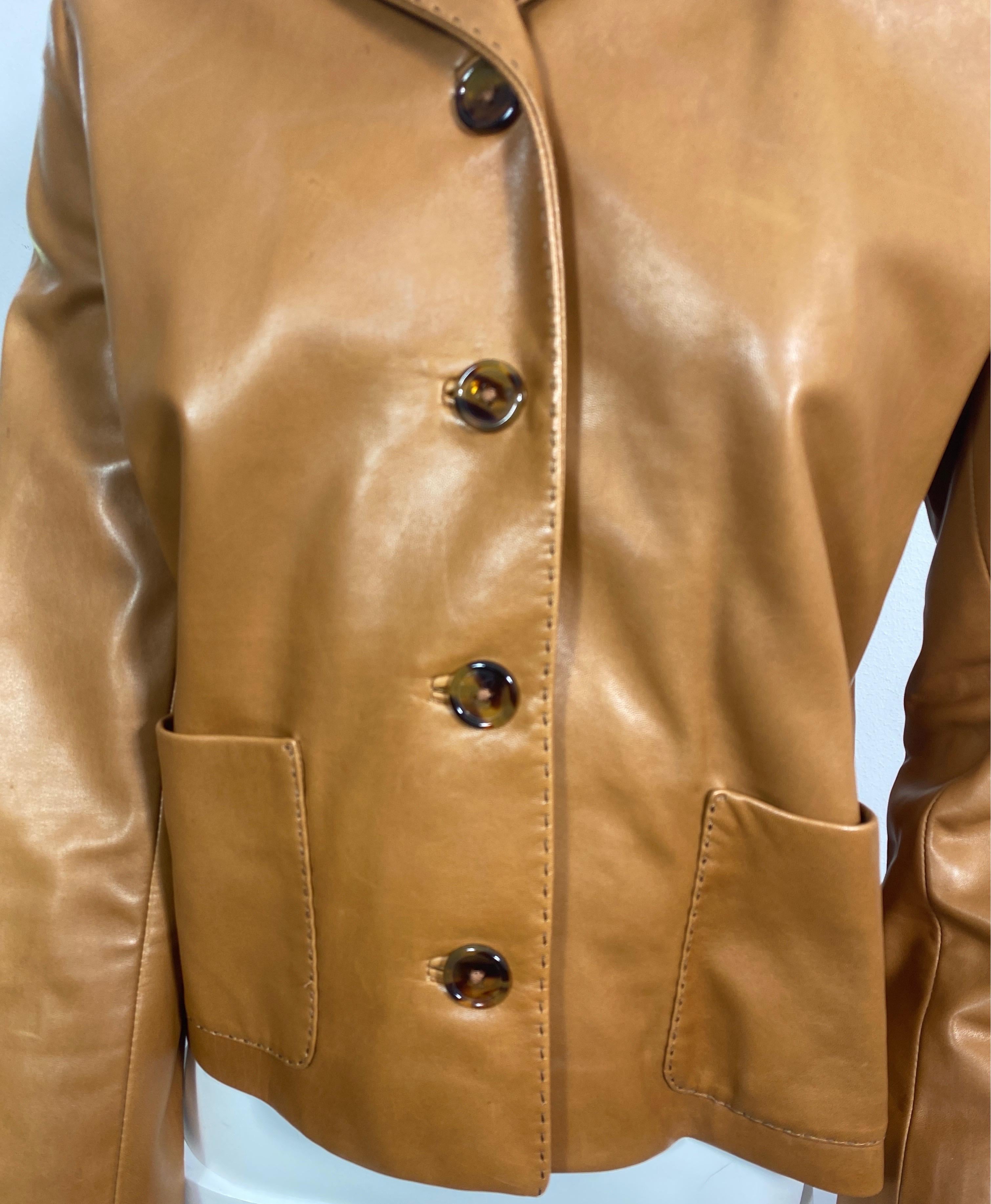 Ralph Lauren Purple Label Caramel Leather Jacket -Size 6 This jacket has a straight almost boxy style to it, is fully lined, is made of a very soft lamb skin leather, has 5 front buttons, 2 front patch pockets, and a detail stitching throughout the