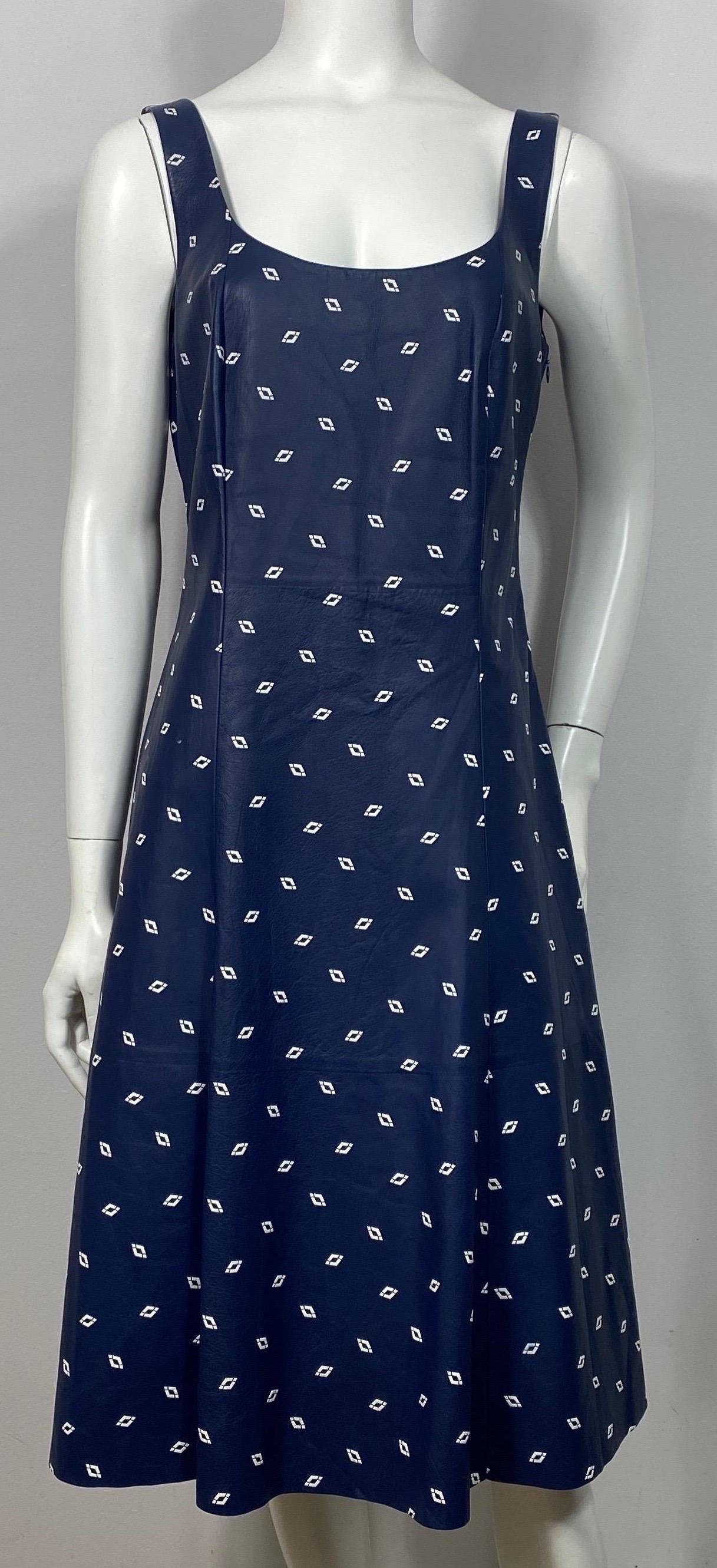 Ralph Lauren Purple Label Navy and White Leather Dress - Size 10  This sleeveless leather dress has an A line cut to it, a low scoop almost square neckline, lined in a navy monogrammed silk, 14” side zipper under the left arm with a top hook and eye