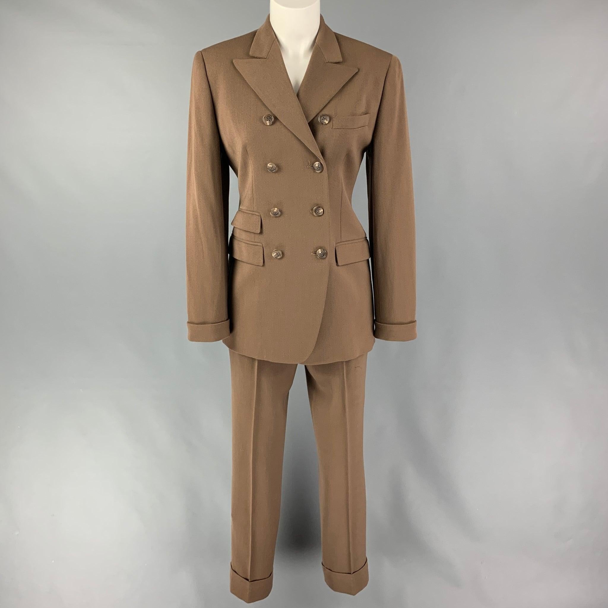 RALPH LAUREN 'Purple Label'
suit comes in a tan wool and includes a double breasted sport coat with a peak lapel and matching flat front trousers. Very Good Pre-Owned Condition. 

Marked:   4/2 

Measurements: 
  -JacketShoulder: 16.5 inches  Bust: