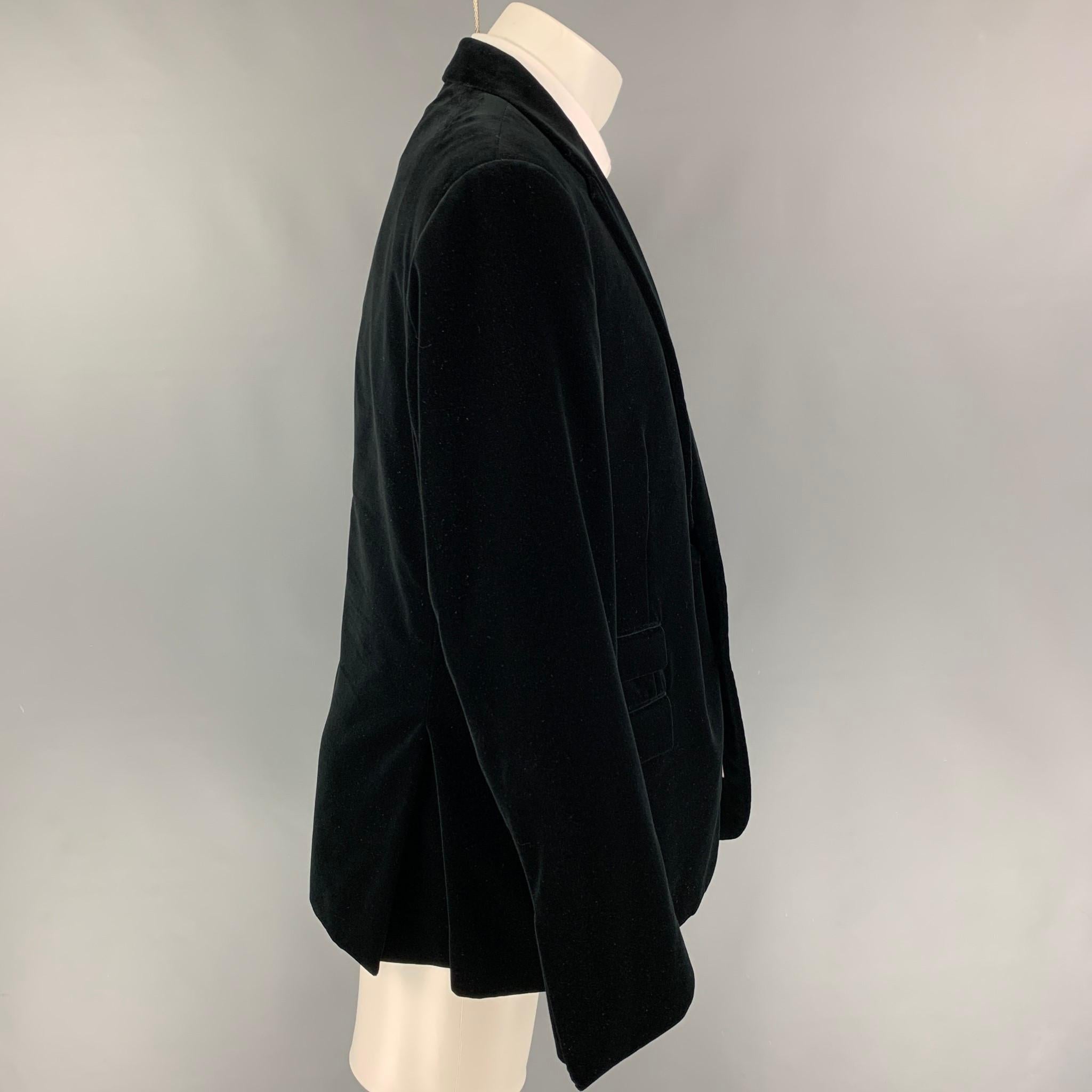 RALPH LAUREN 'Purple Label' custom fit sport coat comes in a black velvet with a full liner featuring a notch lapel, flap pockets, double back vent, and a double button closure. Made in Italy. 

Very Good Pre-Owned Condition.
Marked: 48