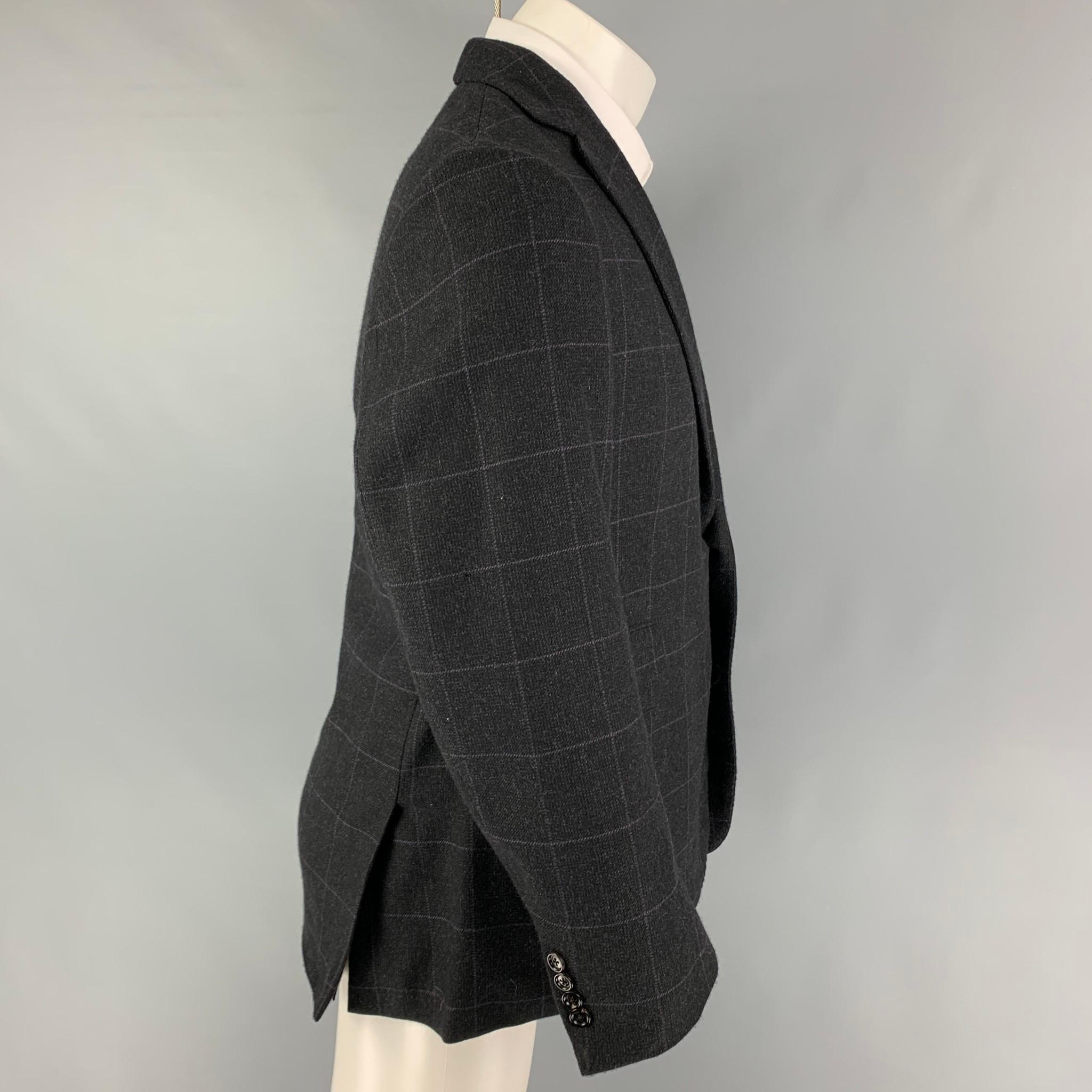 RALPH LAUREN 'Purple Label' sport coat comes in a black & purple window pane wool with a full liner featuring a notch lapel, flap pockets, double back vent, and a double button closure. Made in Italy. 

Very Good Pre-Owned Condition.
Marked: 44