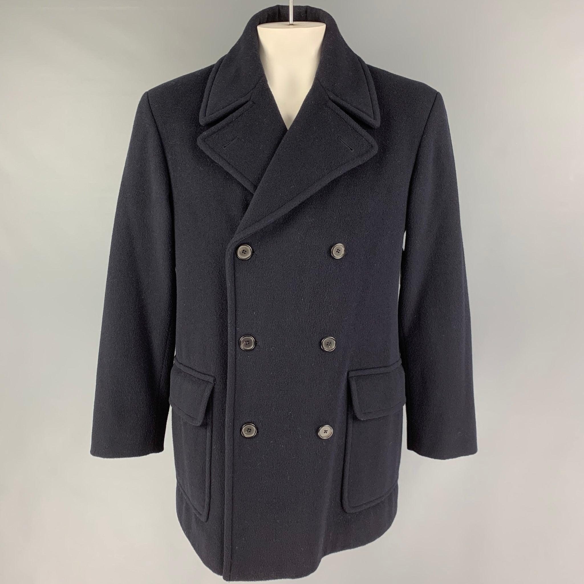 RALPH LAUREN 'Purple Label' coat comes in a navy lana wool with a full liner featuring a notch lapel, storm flap, flap pockets, and a double breasted closure. Made in Italy.Very Good
Pre-Owned Condition. 

Marked:  L 

Measurements: 
 
Shoulder: 20