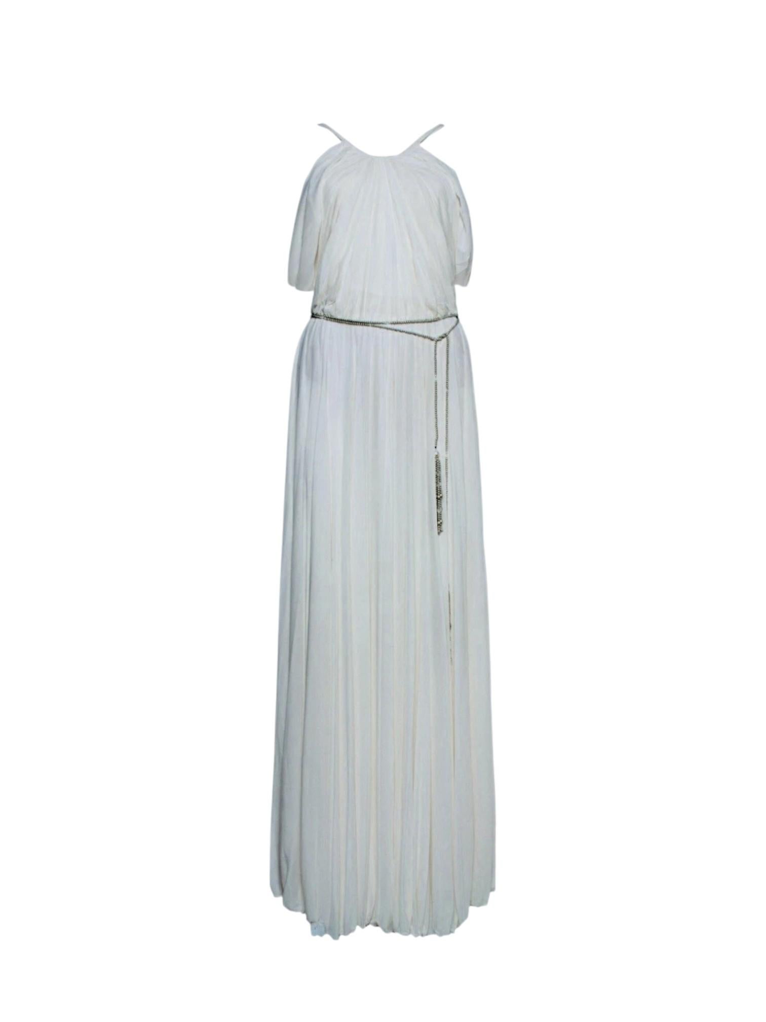 A rare and unforgettable piece from Ralph Lauren’s iconic Spring 2012 runway, this Grecian-inspired ivory gown is a study in elegance and effortless movement. Crafted from fluid draped jersey, it features a high neckline, cut-out shoulders, and an