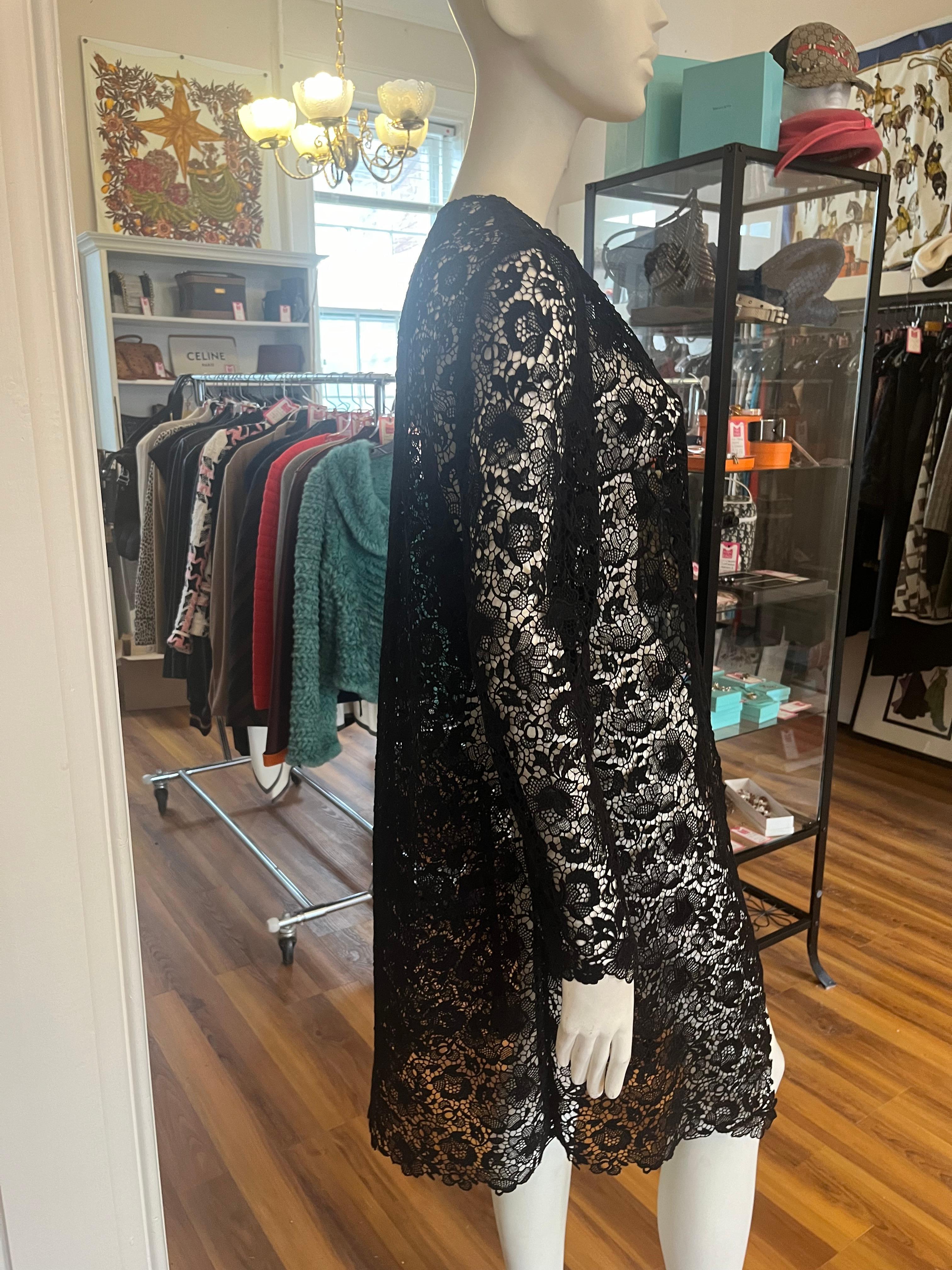 Such a great piece! You can wear it over an evening dress or a pair of jeans.

Beautiful black cotton blend lace duster it was manufactured in the USA. Look at the close up pictures of this piece and you will see a floral pattern. 

This duster has