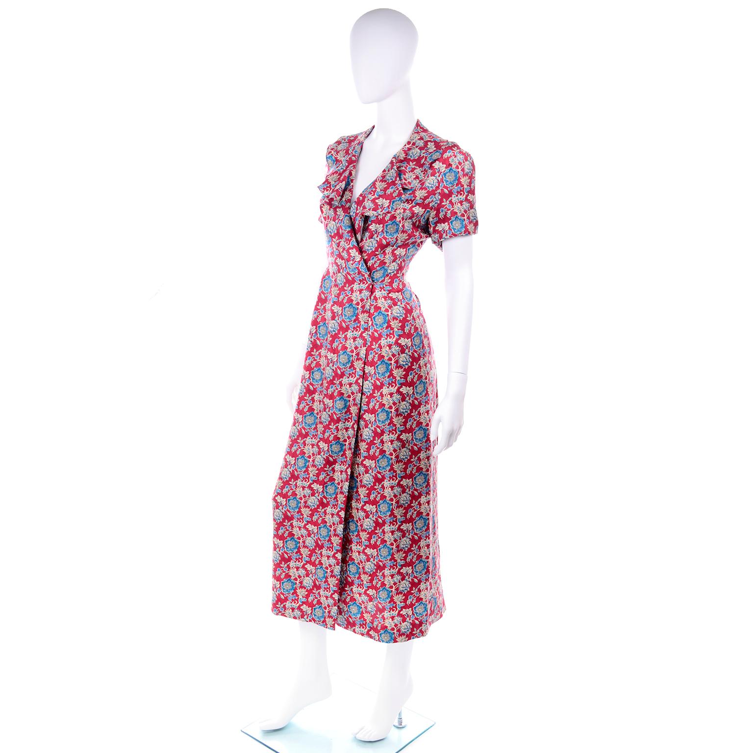 This is a lovely vintage Ralph Lauren silk wrap dress with a ruffled neckline in a red and blue floral print. This pretty short sleeve day dress falls mid calf or longer depending on your height and is marked a size 4. Please review all of the
