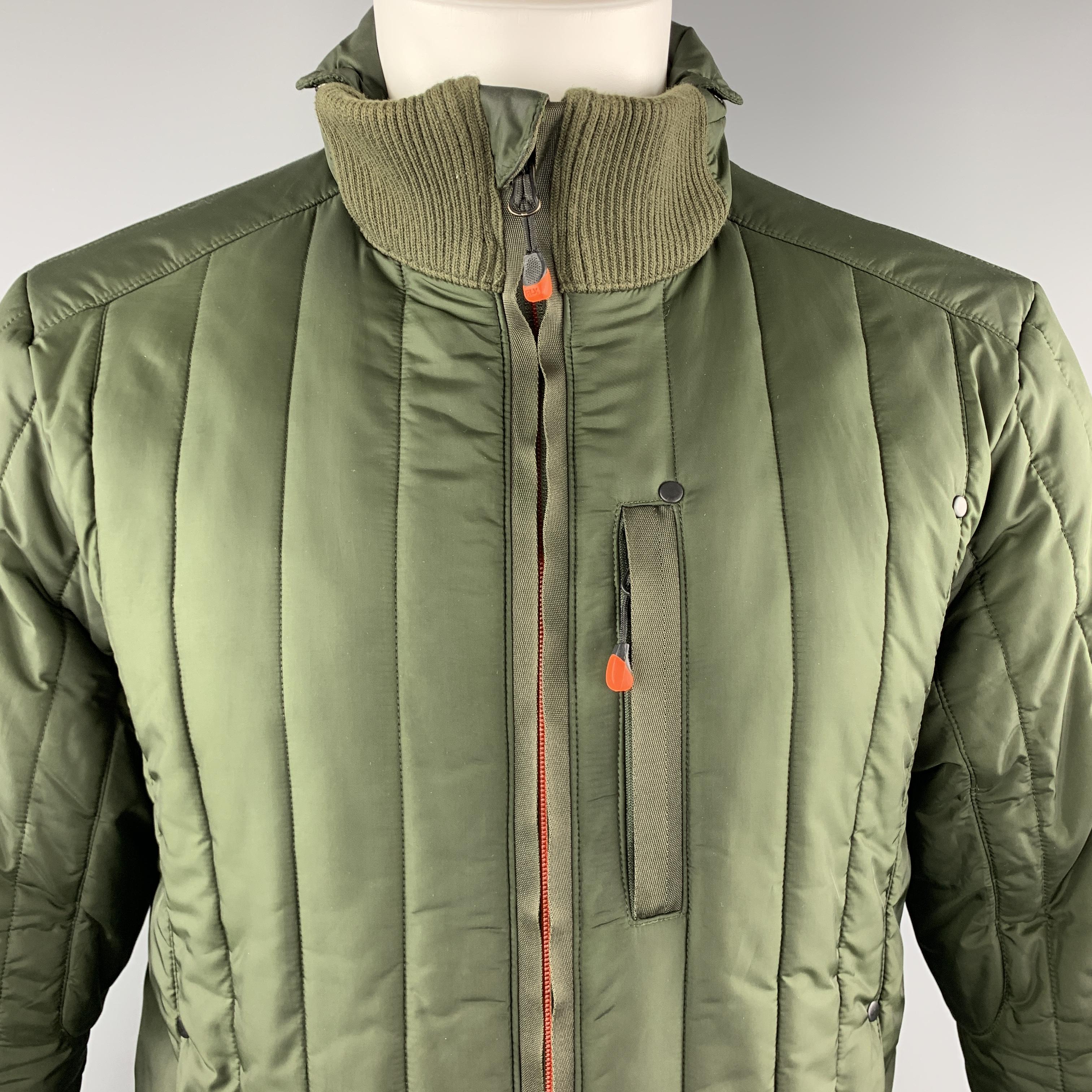 RLX by RALPH LAUREN comes in olive green quilted nylon with orange zippers, three slit zip pockets, and high ribbed knit collar with snap detail. Minor wear on liner.

Excellent Pre-Owned Condition.
Marked: M

Measurements:

Shoulder: 17 in.
Chest: