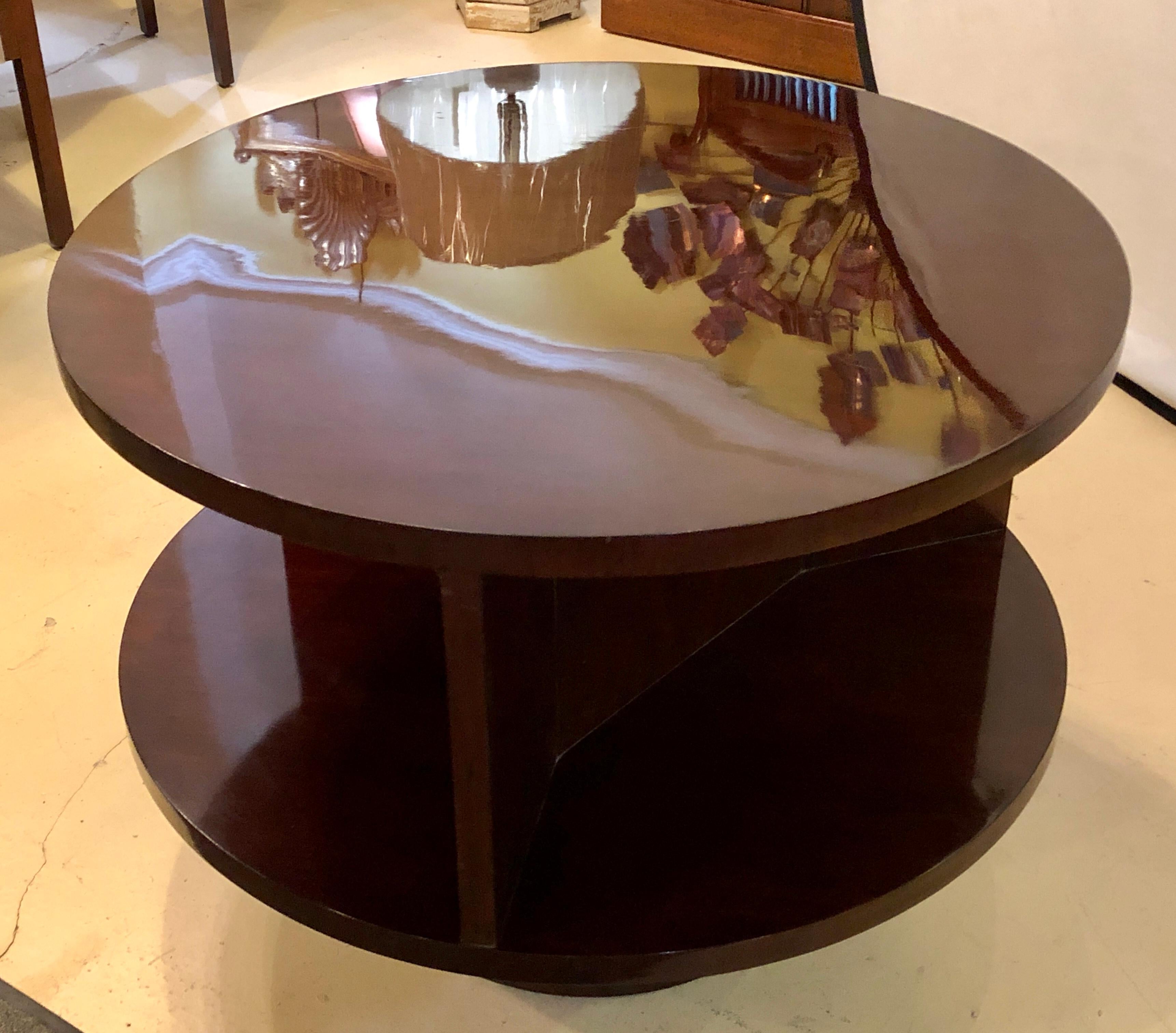 Ralph Lauren round mahogany coffee or end table having been finely polished. The sides with wide storage area. This table new lists for over $5000.