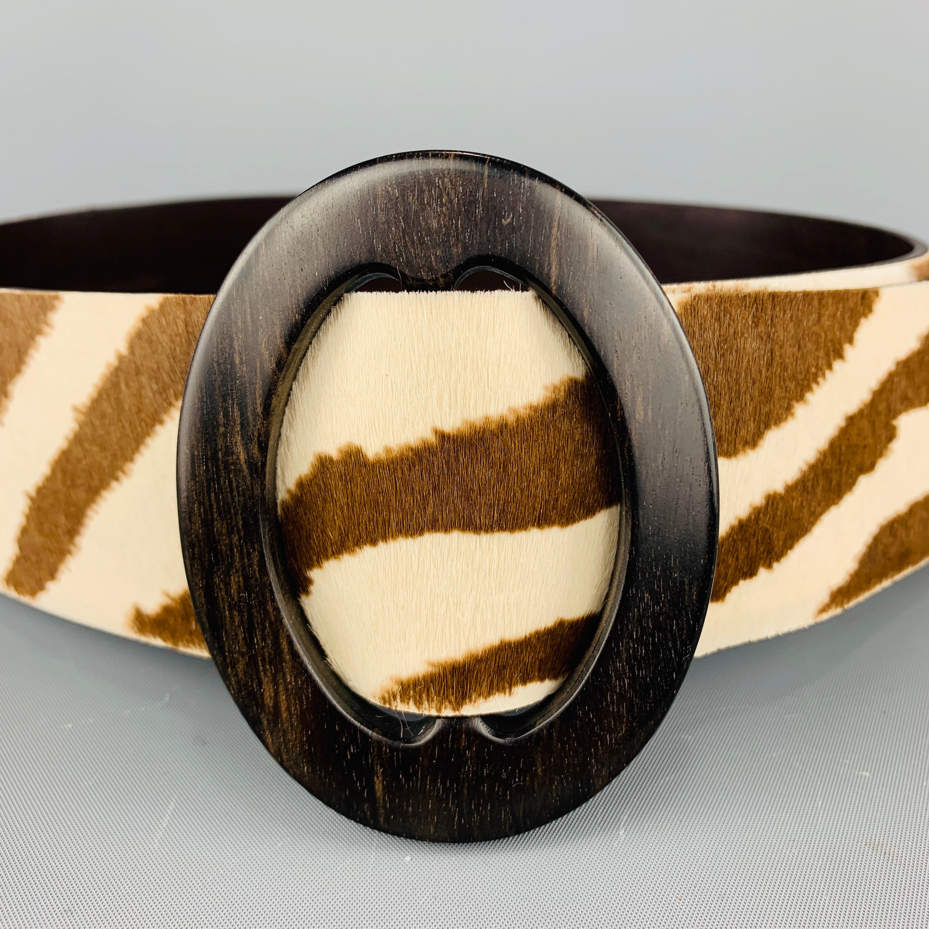 RALPH LAUREN COLLECTION waist belt features a thick brown and cream zebra print ponyhair leather strap with an oval wood adjustable buckle. Made in Italy.
 
Excellent Pre-Owned Condition.
Marked: S
 
Length: 37 in.
Width: 2 in.
Fits: Up to 32