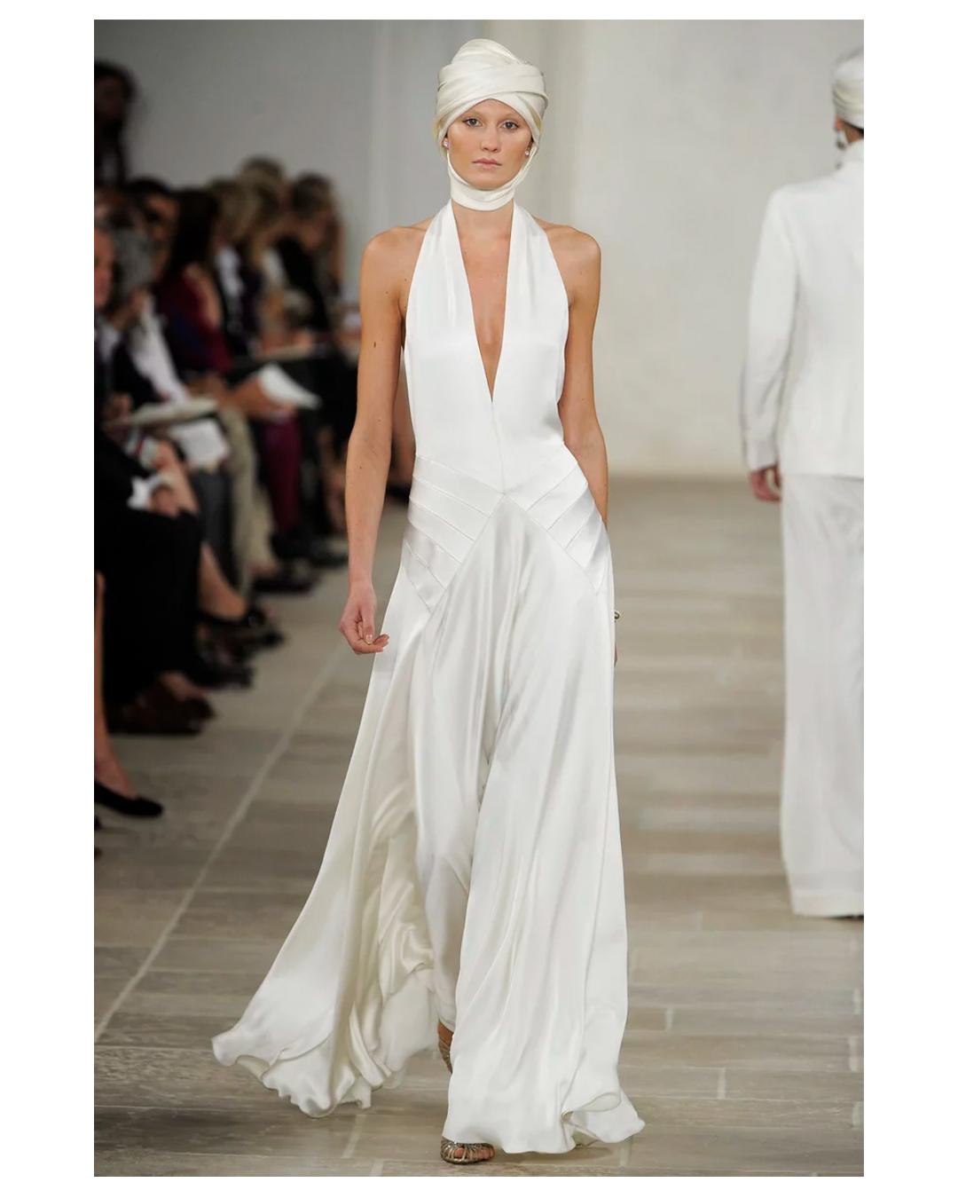 LOVE LALI VINTAGE

An incredibly rare gown by Ralph Lauren Collection Purple label S/S 2009
Called the Fabienne dress
The most beautiful halter neck gown in ivory silk with a plunging neckline and low cut back. This would work wonderfully for a