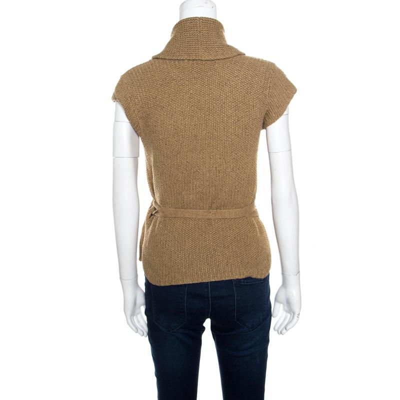 This cardigan from Ralph Lauren is simple and stylish. Designed in a sand brown shade, this cardigan features cap sleeves and a wrap design with a tie. Hand knit to perfection, this piece is just wonderful enough to keep you in style.

Includes: The