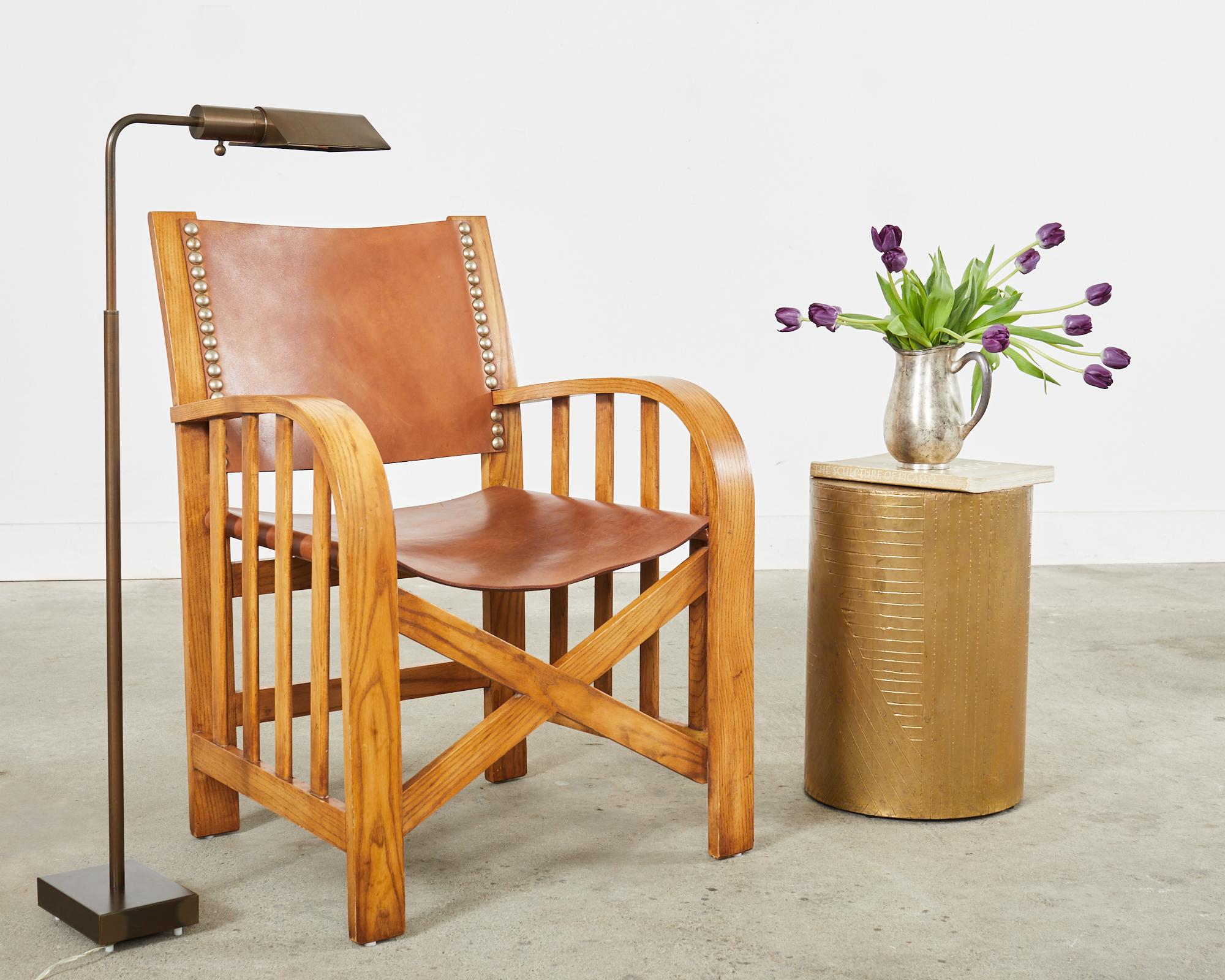Distinctive country American armchair made of solid ash designed by Ralph from the sheltering sky collection. The frames have gracefully curved wide arms nearly 27 inches high. The arms are supported by open slat sides with an x-form stretcher in