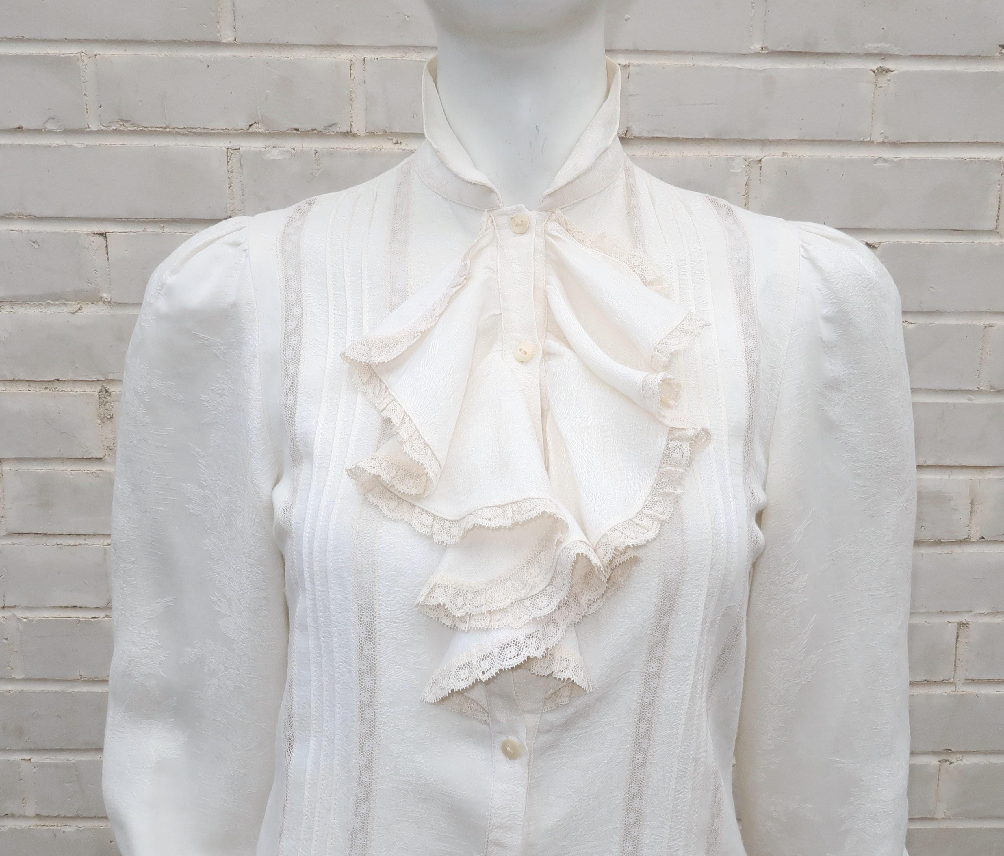 The vintage inspiration for this lovely Ralph Lauren blouse could be an Edwardian beauty in a John Singer Sargent portrait.  The romantic combination of a blended ivory white silk and cotton jacquard with lace inserts and a jabot style ruffle at the