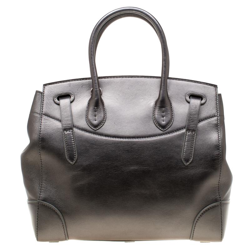 This Ralph Lauren Ricky 33 bag is simply breathtaking. Meticulously crafted from leather, the bag delights not only with its appeal but structure as well. It is held by two top handles, detailed with silver-tone hardware and equipped with spacious