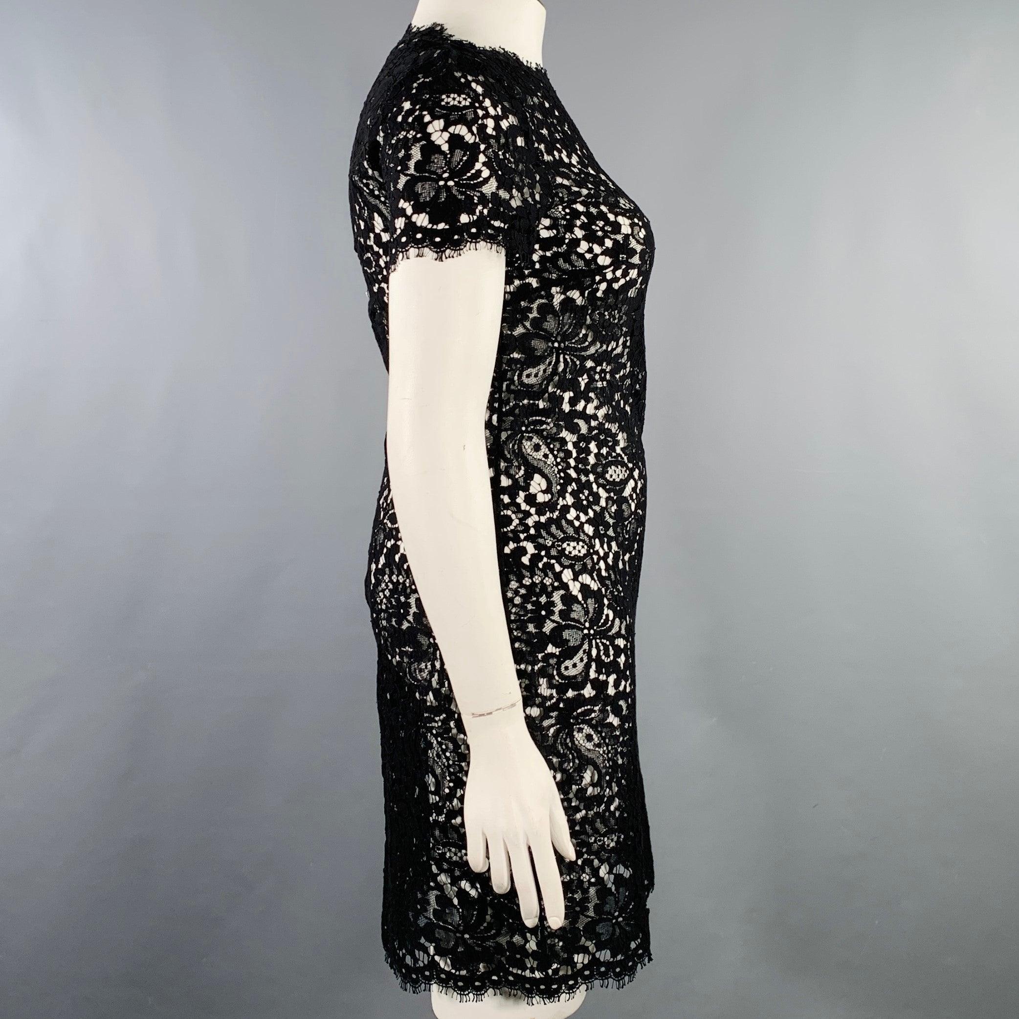 RALPH LAUREN BLACK LABEL dress in a black lace cotton blend featuring short sleeves and a back zip up closure. Made in USA.Excellent Pre-Owned Condition. 

Marked:   10 

Measurements: 
 
Shoulder: 15 inches Bust: 34 inches Waist: 32 inches Hip: 36