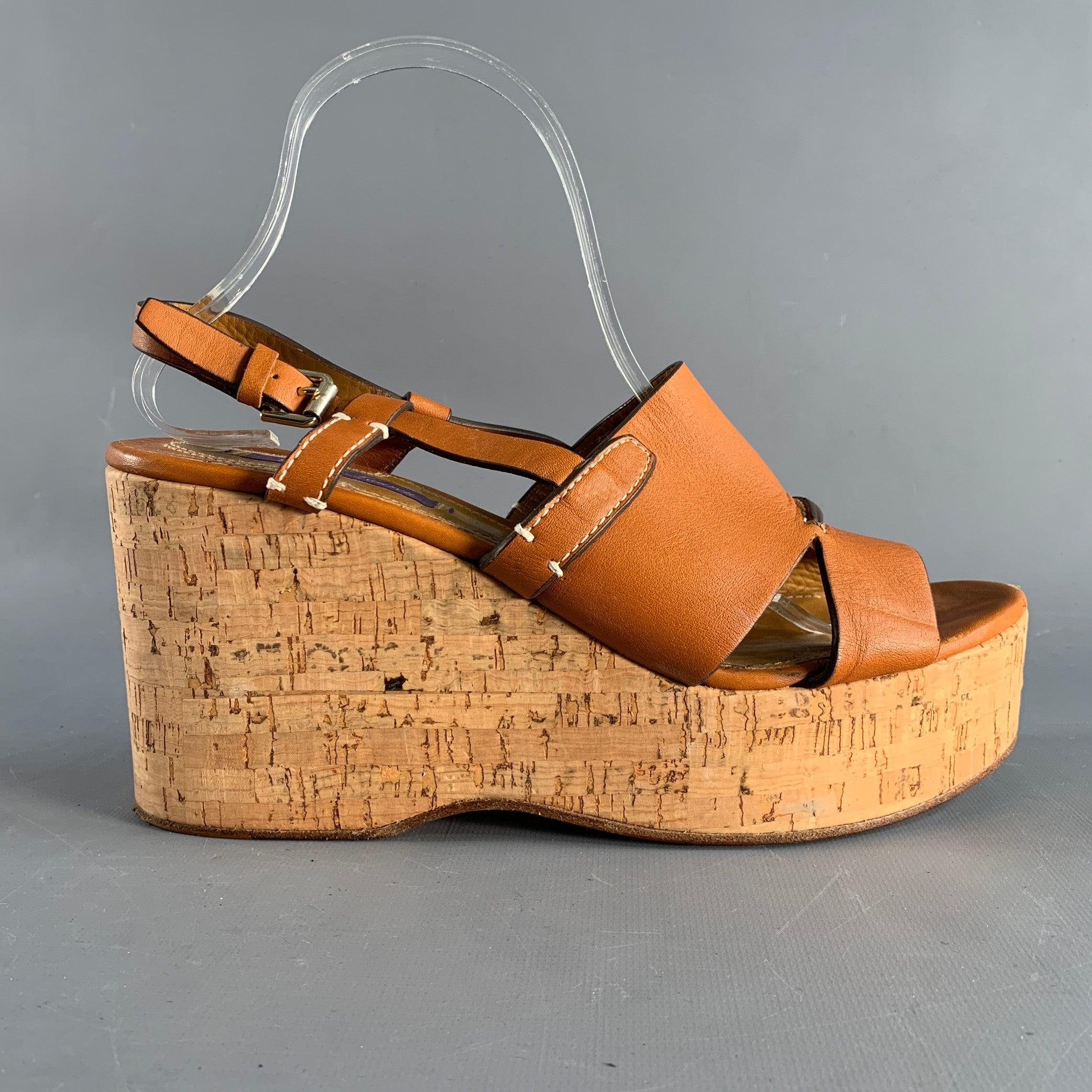 RALPH LAUREN COLLECTION by sandals in tan leather and natural cork featuring a natural rope trim, open toe, white accents, and a wedge heel. Made in Spainches Excellent Pre-Owned Condition. 

Marked:   40 B 

Measurements: 
  Heel: 4 inches  
  
 