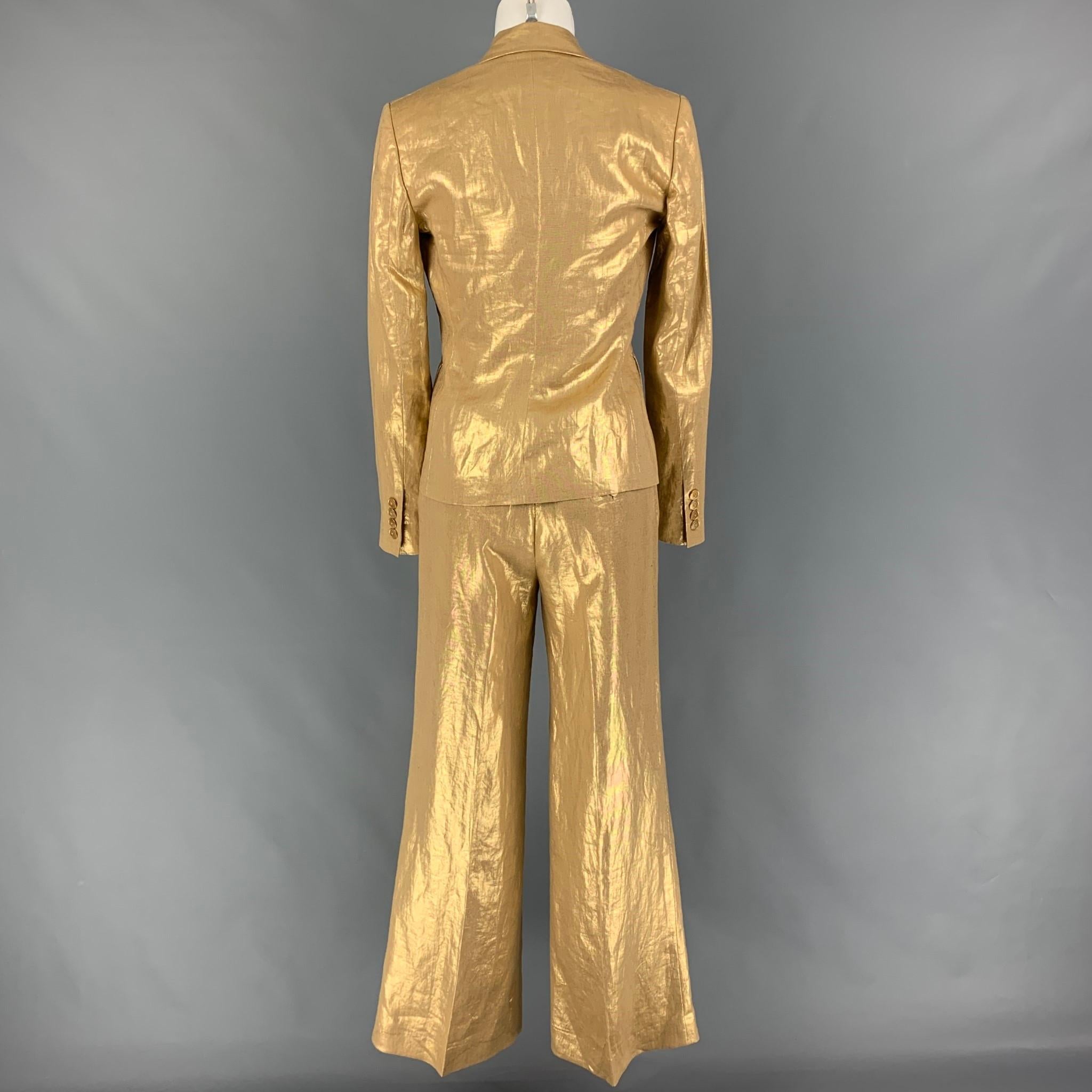RALPH LAUREN 'Black Label' suit comes in a gold metallic linen featuring a notch lapel, flap pocket, single spread blaze and matching wide leg pants. Made in USA. 

Excellent Pre-Owned Condition.
Marked: 2

Measurements:

-Jacket
Shoulder: 15