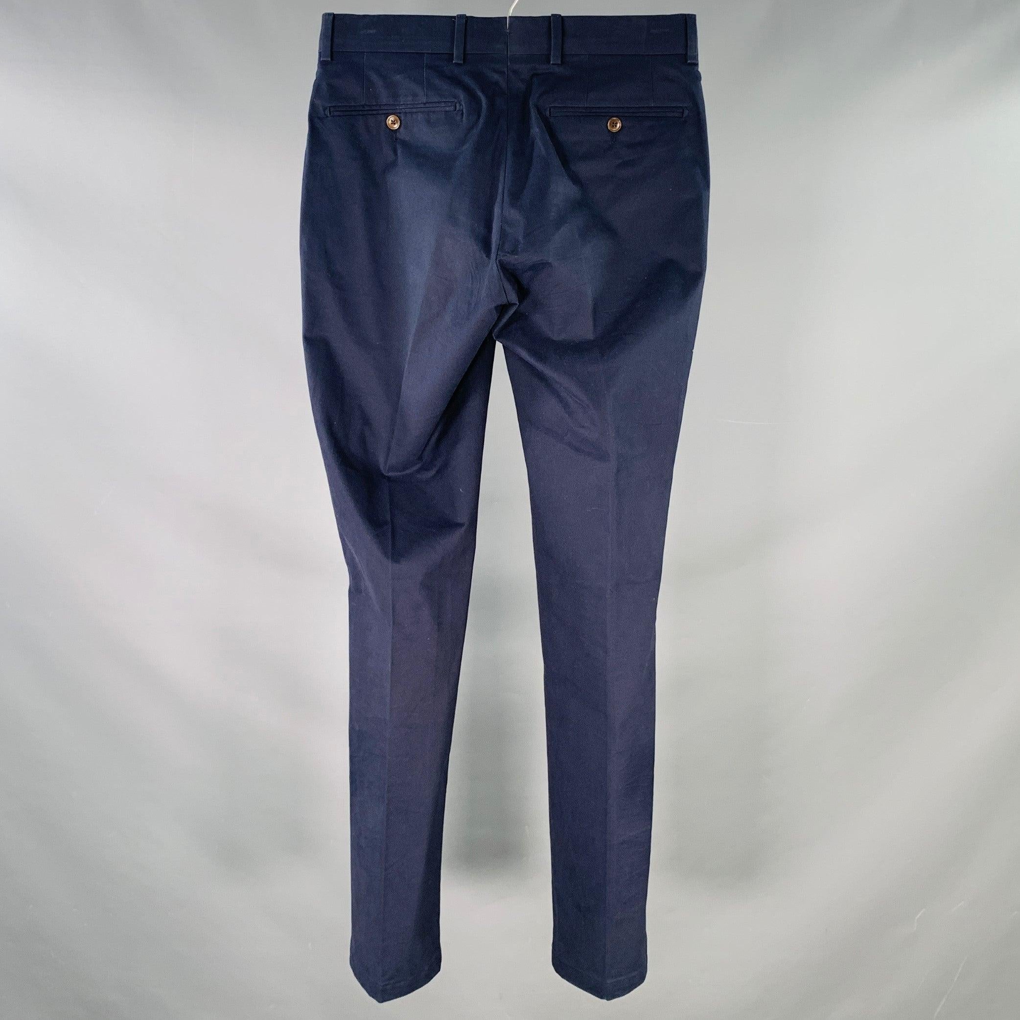 RALPH LAUREN PURPLE LABEL dress pants
in a navy cotton stretch blend fabric featuring a flat front, slim straight fit, and zip fly closure. Made in Italy.
Note: this garment has been professionally altered to fit previous wearer, please double check