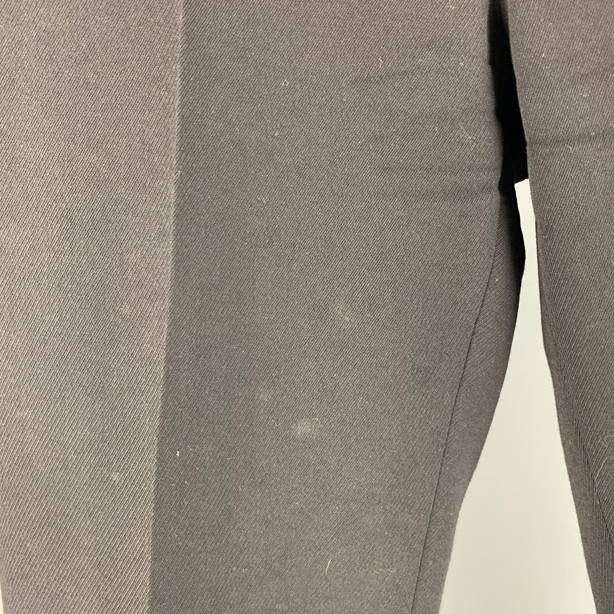 RALPH LAUREN PURPLE LABEL dress pants comes in black wool twill material featuring a medium waist, and a zip up fly closure. Good Pre-Owned Condition. AS IS. Moderate signs of wear. 

Marked:  36 

Measurements: 
 Waist: 36 inches Rise: 10.5 inches