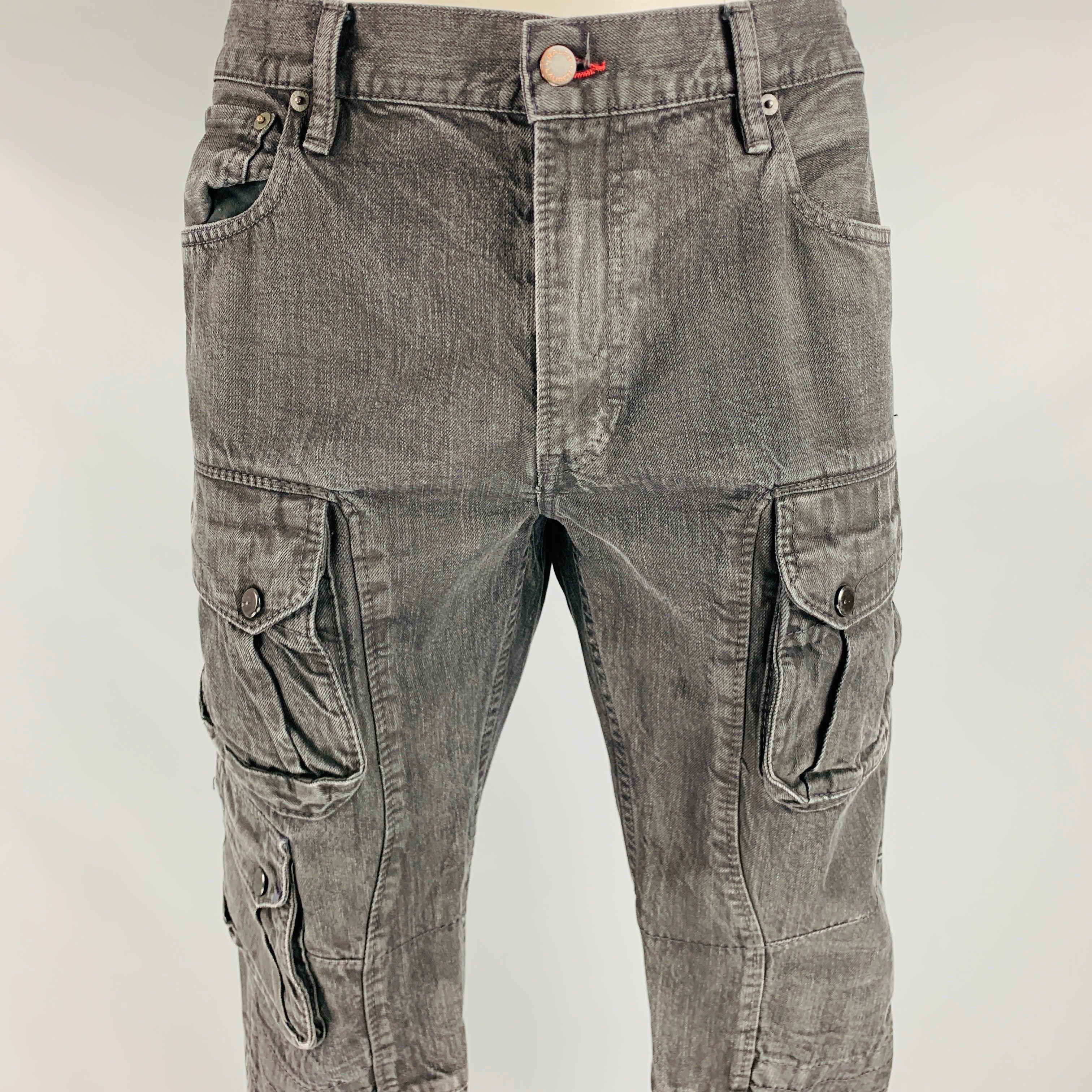 RALPH LAUREN BLACK LABEL jeans
in a black wash denim fabric featuring multiple utilitarian snap pockets, ankle zip & snap details, and zip fly closure. Excellent Pre-Owned Condition. 

Marked:   36/32 

Measurements: 
  Waist: 36 inches Rise: 9.5