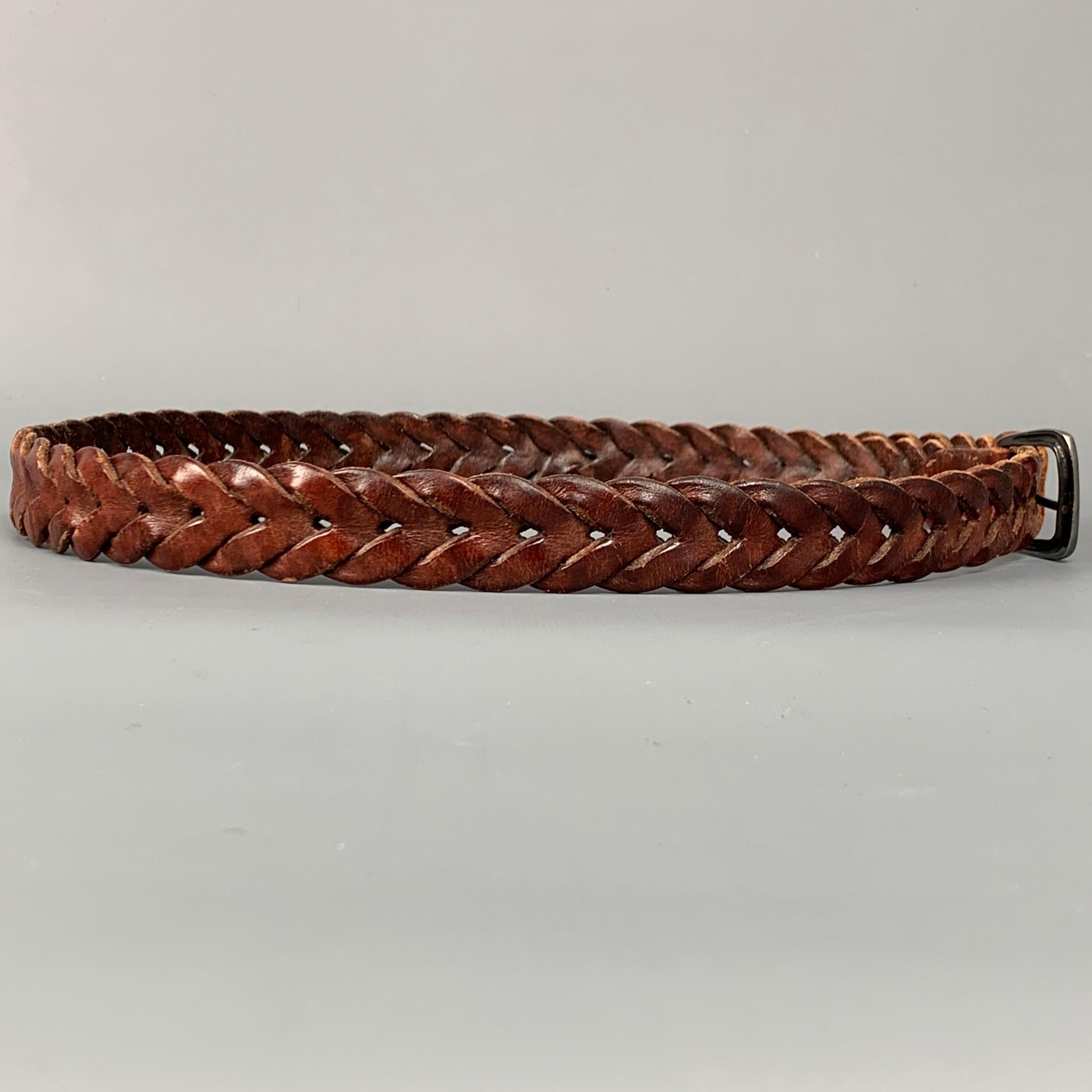 RALPH LAUREN belt comes in a brown woven leather featuring a sterling silver tip detail and buckle. Made in England.

Very Good Pre-Owned Condition.
Marked: 36/90

Length: 43 in.
Width: 0.75 in.
Buckle: 1.5 in. 
