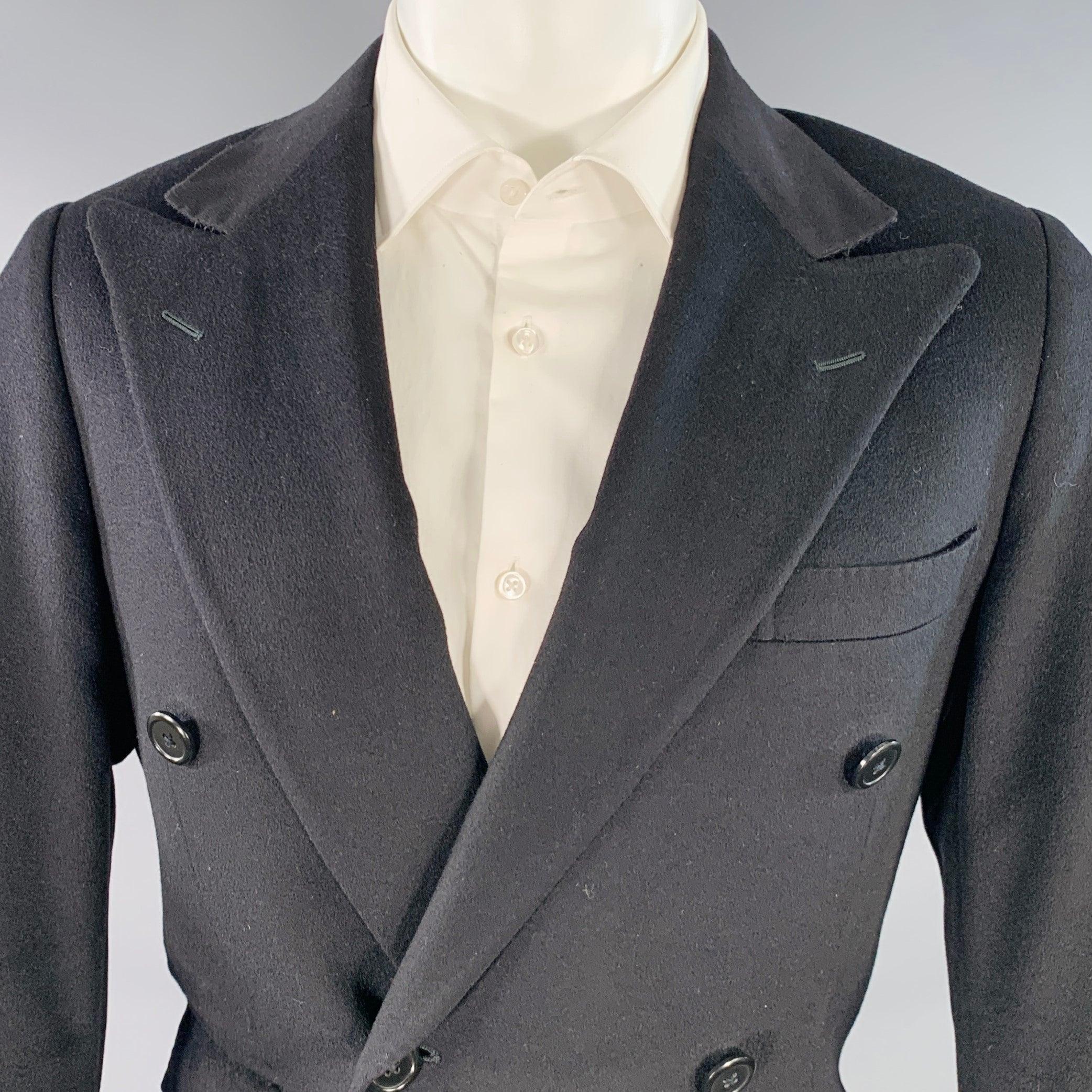 POLO by RALPH LAUREN sport coat in a black cashmere featuring a double breasted style, peak lapel, double vented back, and double button closure. Note: the sleeves on this garment have been professionally altered and are slightly uneven in length.