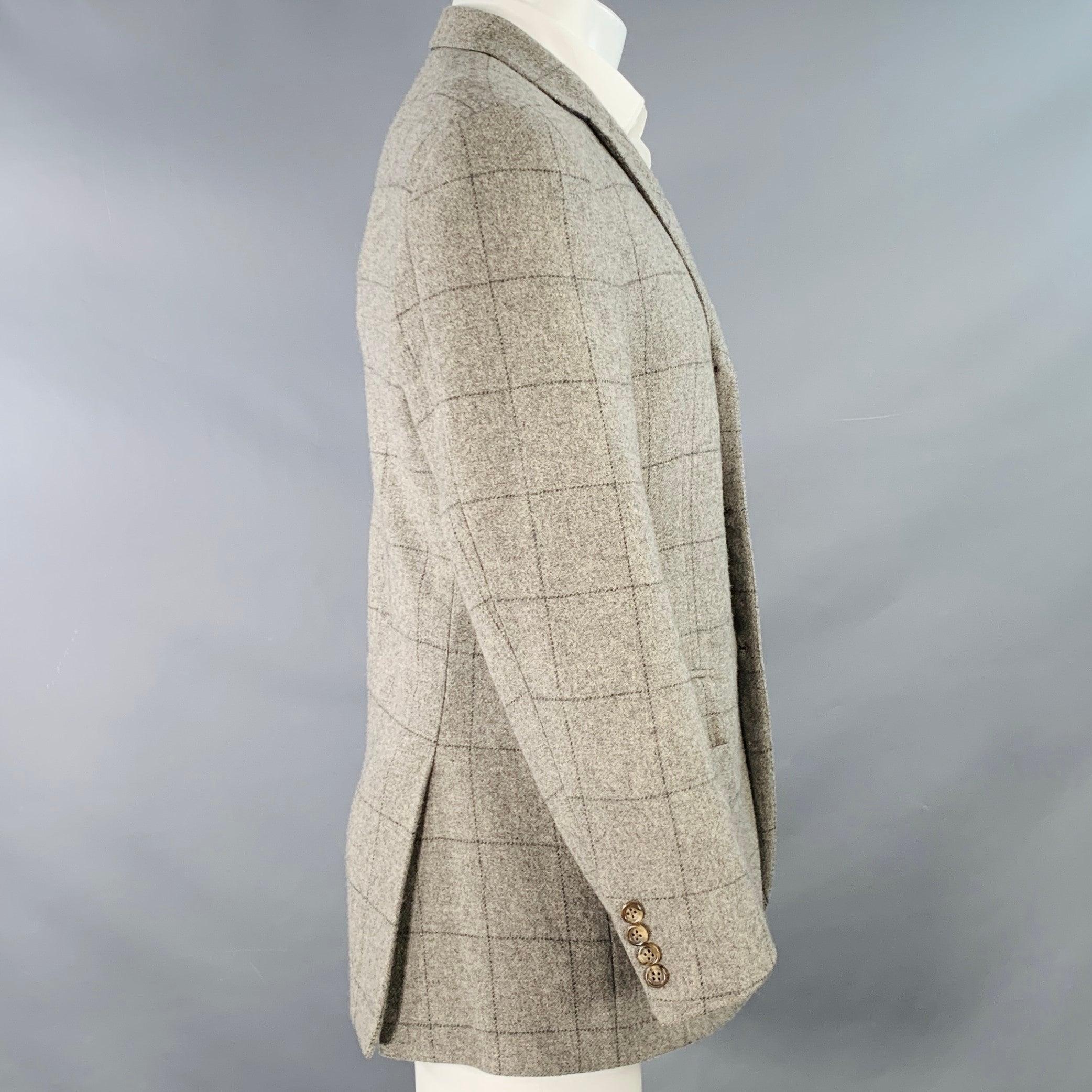 POLO by RALPH LAUREN sport coat in a grey and black cashmere featuring a windowpane pattern, notch lapel, double vented back, and three button closure. Note: the sleeves on this garment have been professionally altered and are slightly uneven in