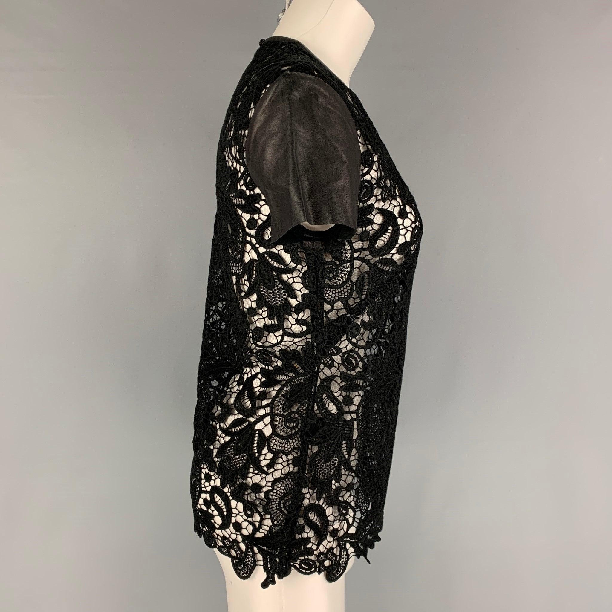 RALPH LAUREN 'Black Label' blouse comes in a black see through lace cotton featuring leather sleeves and a back button closure.
Very Good
Pre-Owned Condition. 

Marked:   4 

Measurements: 
 
Shoulder: 15.5 inches  Bust: 32 inches  Sleeve: 6 inches 