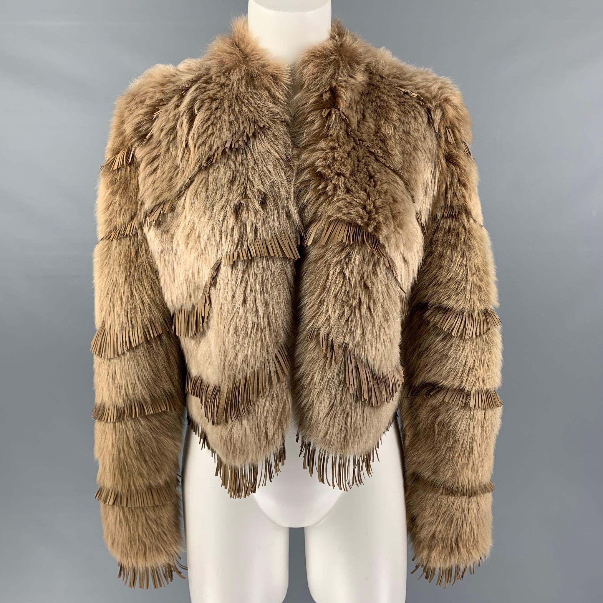 RALPH LAUREN 'COLLECTION' cropped jacket comes in a tan lamb shearling fur with a lamb leather lining featuring leather fringe details, and hook and eye closure. Made in Italy.

Excellent Pre-Owned Condition.
Marked: 4

Measurements:

Shoulder: 16