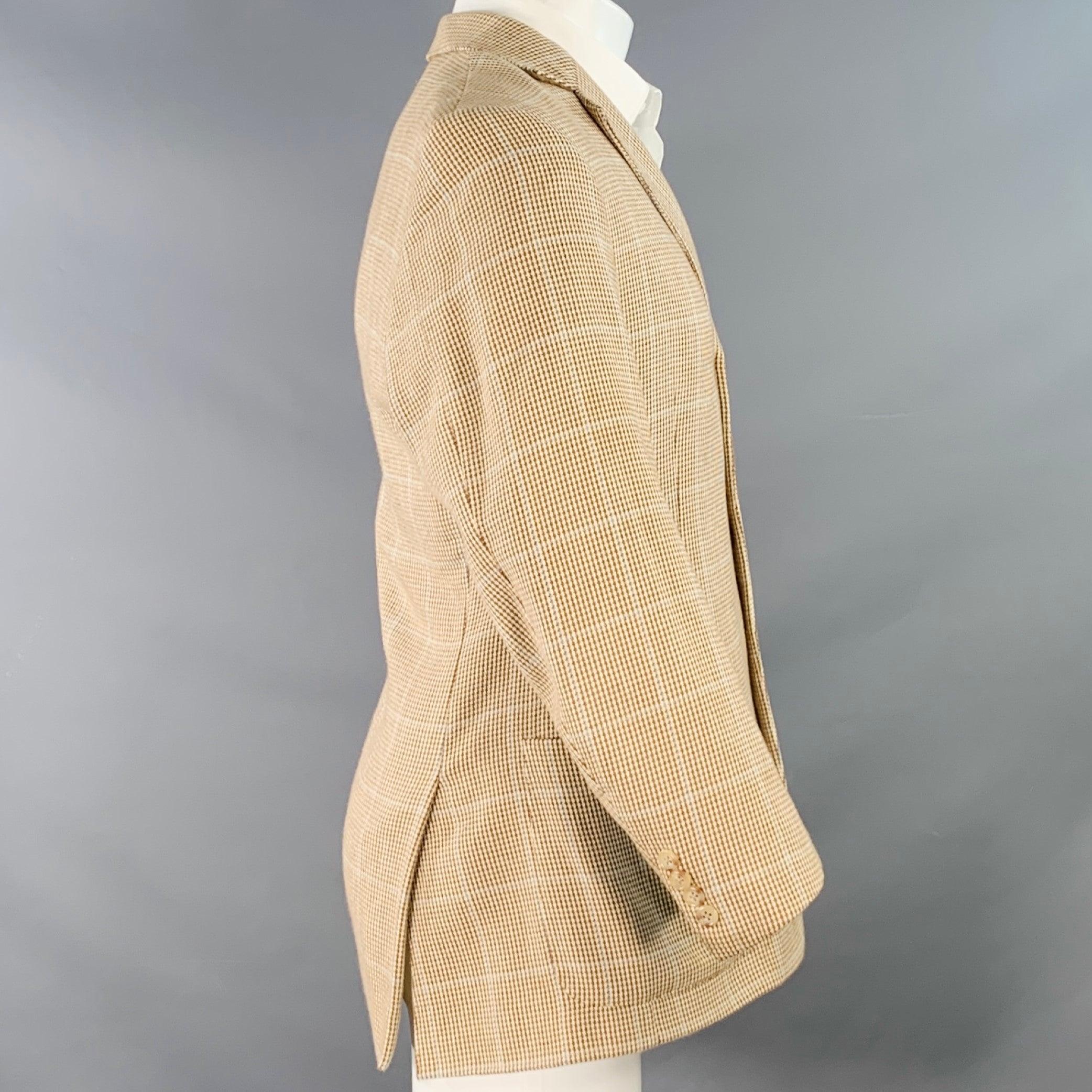 POLO by RALPH LAUREN sport coat
in a brown and beige cotton woven fabric featuring a plaid pattern, notch lapel, double vented back, and three button closure. Note: the sleeves on this garment have been professionally altered and are slightly uneven