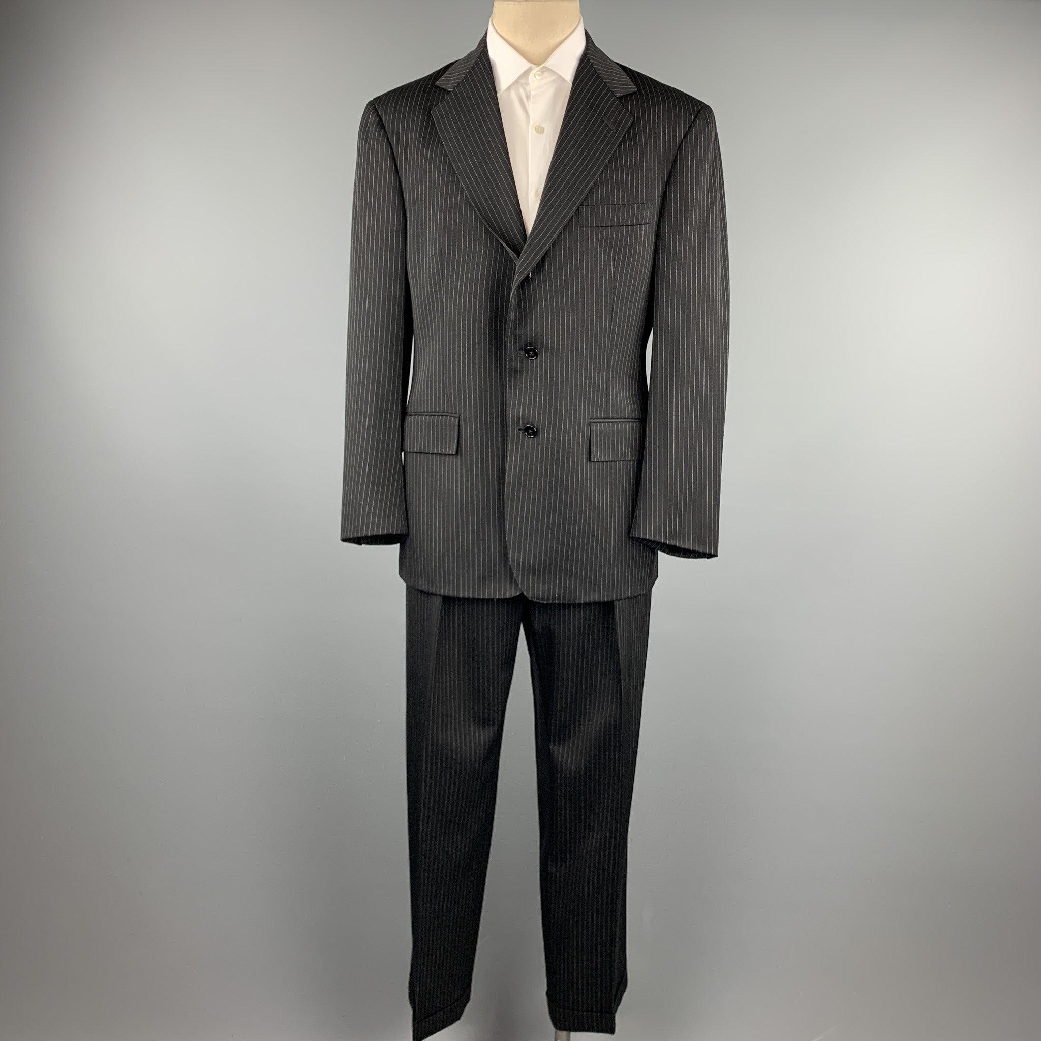 POLO by RALPH LAUREN
suit comes in a black stripe wool and includes a single breasted, three button sport coat with a notch lapel and matching flat front trousers.
Very Good Pre-Owned Condition. 

Marked:   40 

Measurements: 
  -JacketShoulder: