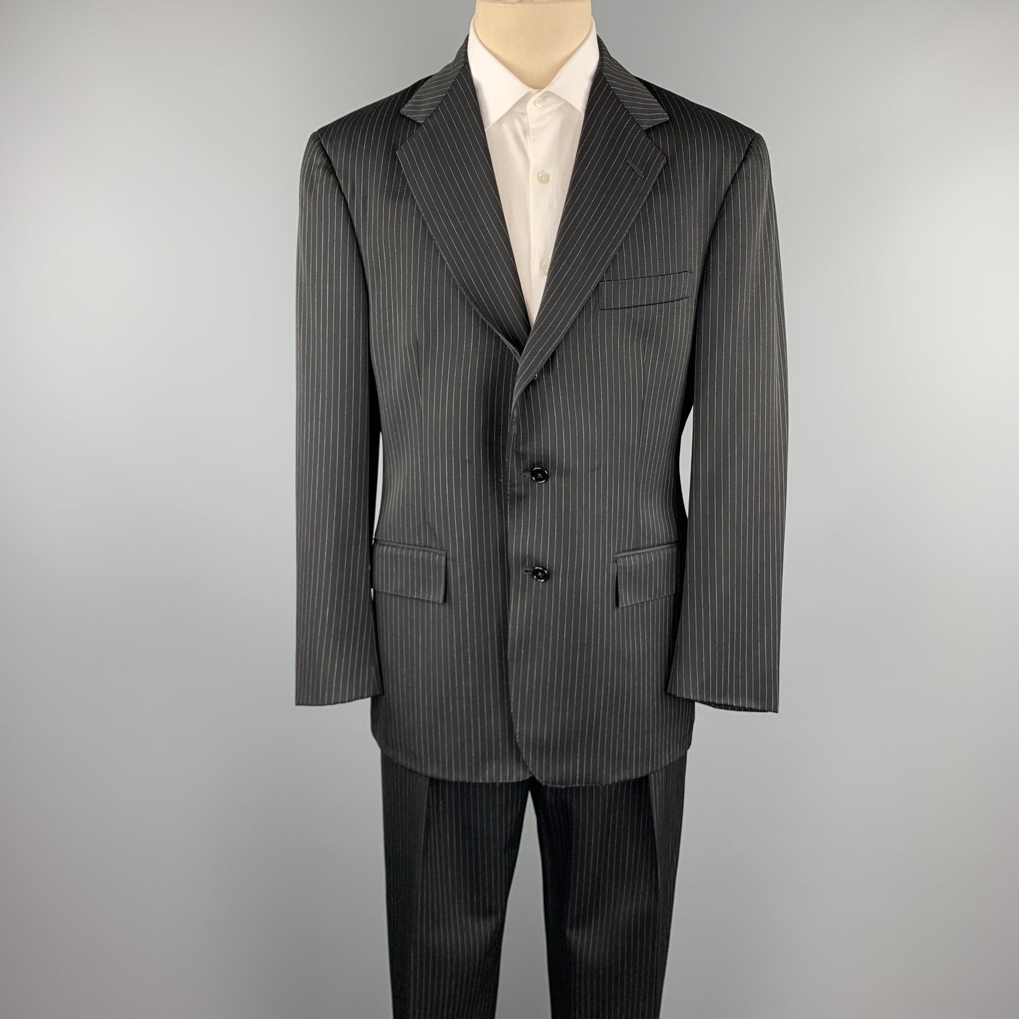 POLO by RALPH LAUREN suit comes in a black stripe wool and includes a single breasted, three button sport coat with a notch lapel and matching flat front trousers. 

Very Good Pre-Owned Condition.
Marked: 40

Measurements:

-Jacket
Shoulder: 19.5