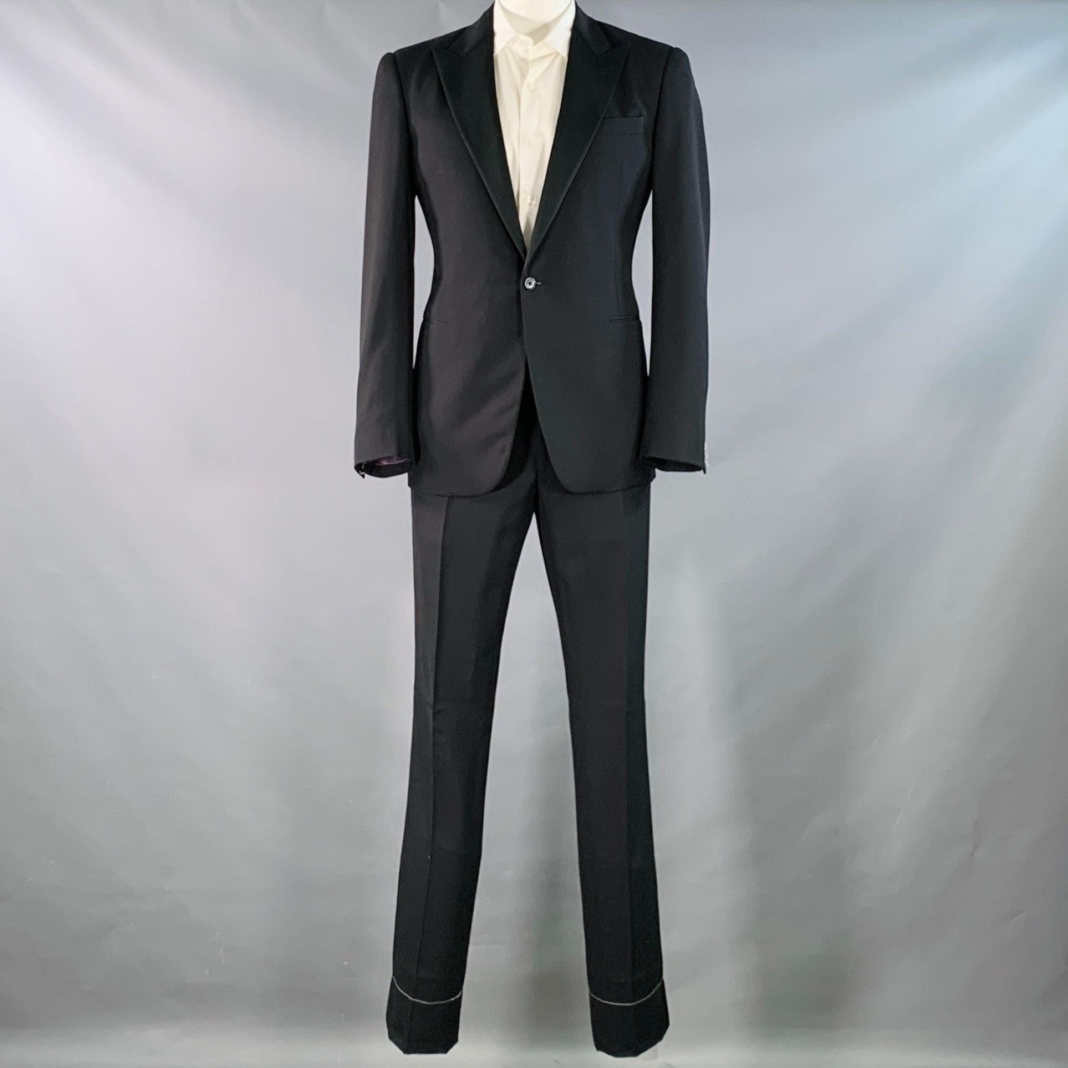 RALPH LAUREN PURPLE LABEL tuxedo
in a black wool with a full liner and includes a single breasted, single button sport coat with a peak lapel and matching flat front trousers. Hem has been left unfinished to tailor to your perfect fit.New with Tags.