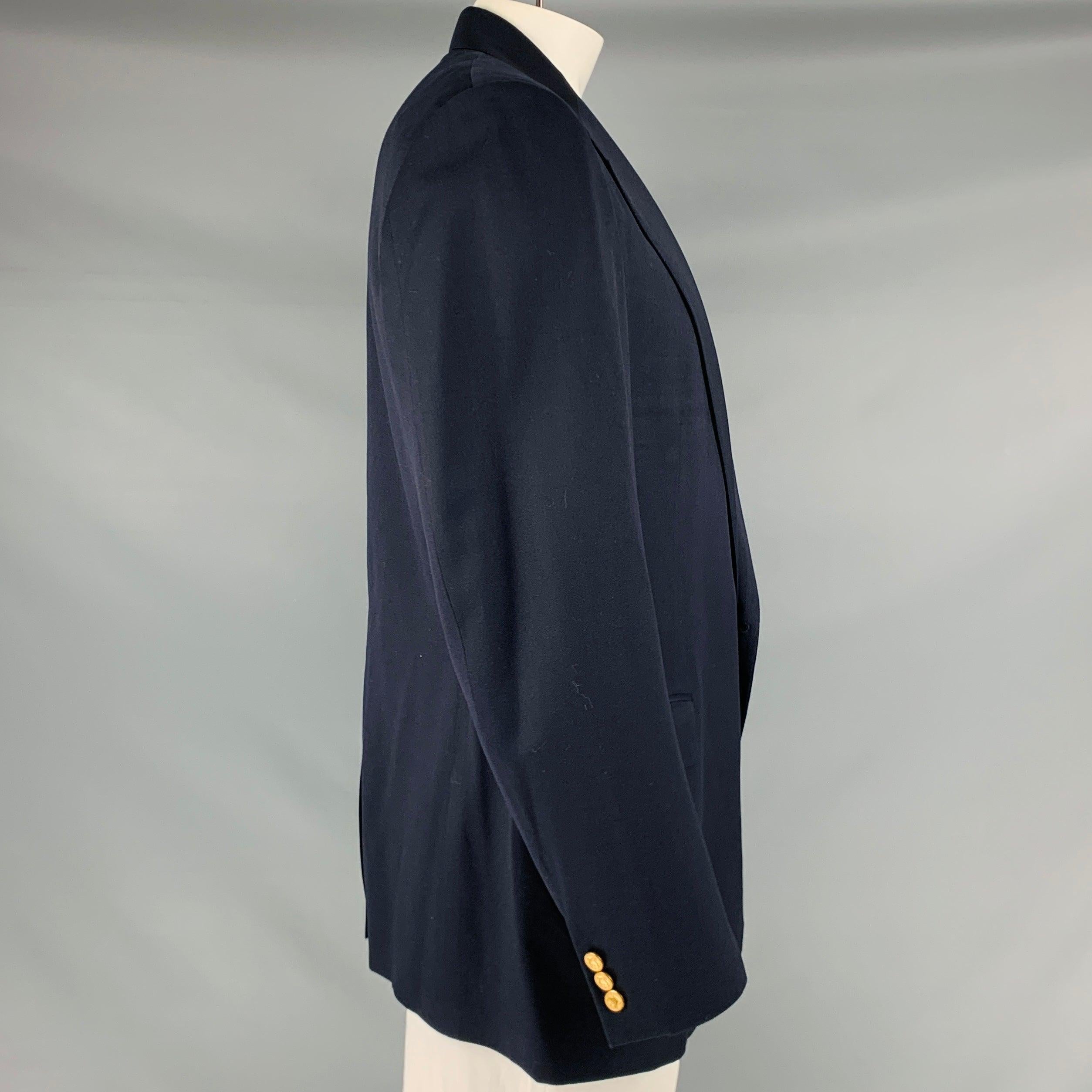 POLO by RALPH LAUREN sport coat
in a navy wool fabric featuring notch lapel, three pockets, and double button closure. Made in Italy.Very Good Pre-Owned Condition. Minor signs of wear. 

Marked:   size not marked, fabric tag faded. 

Measurements: 
