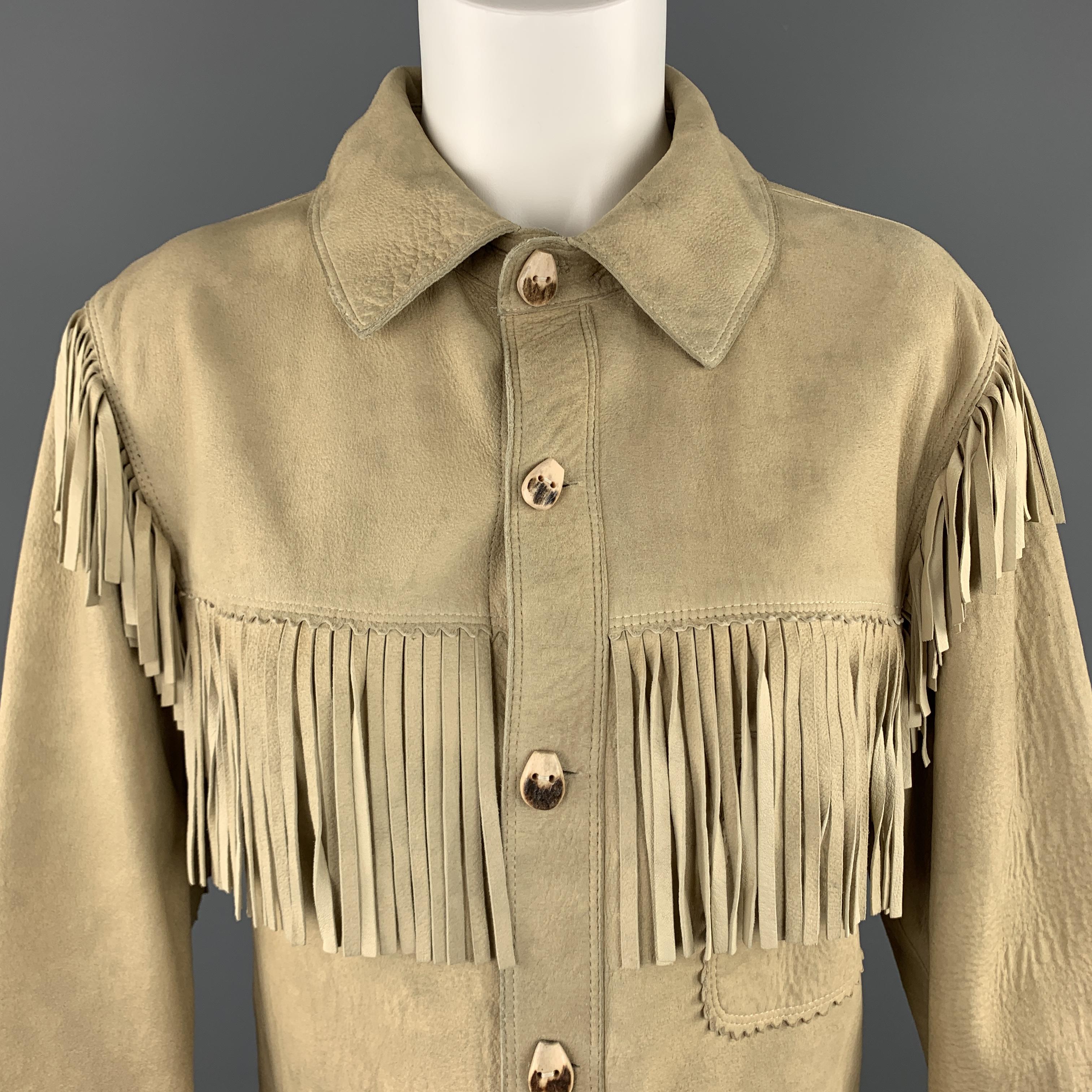RALPH LAUREN PURPLE LABEL jacket comes in beige sueded lamb skin leather with a pointed collar, wood buttons, patch pockets, and fringe trim. natural aging throughout. As-is. Made in Italy.

Good Pre-Owned Condition.
Marked: